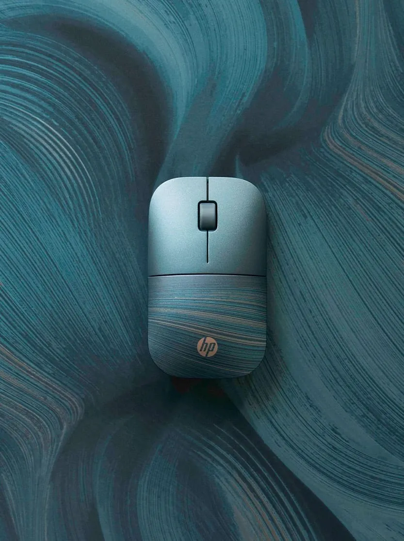 An hp mouse that is has green, blue and gray swirls on a similar background.