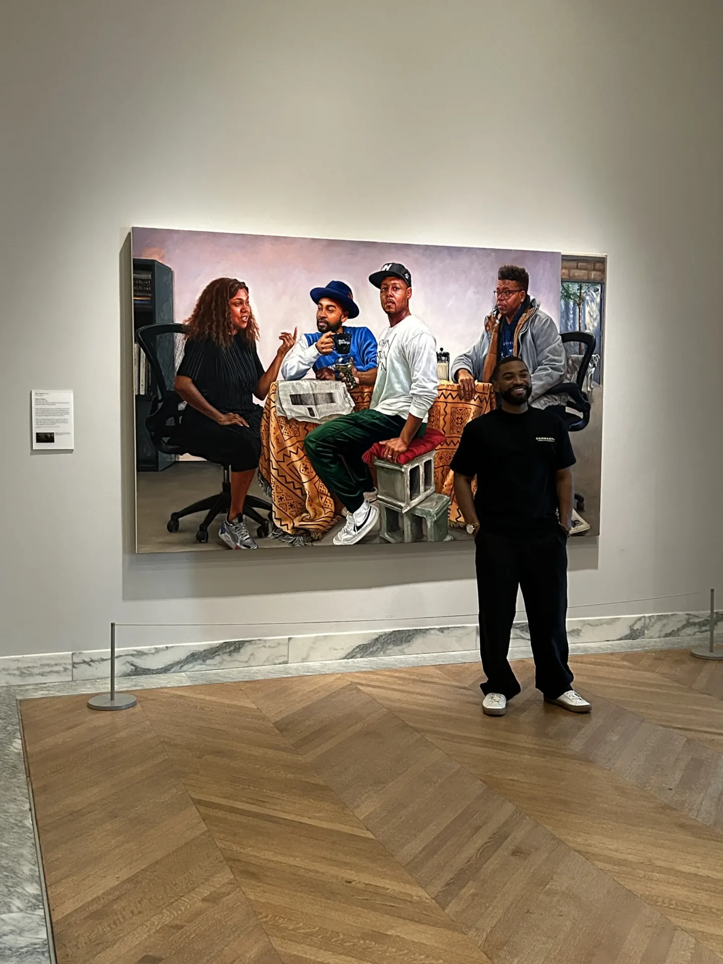 Mario Moore in front of his painting “The Council” located at the Detroit Institute of Arts.