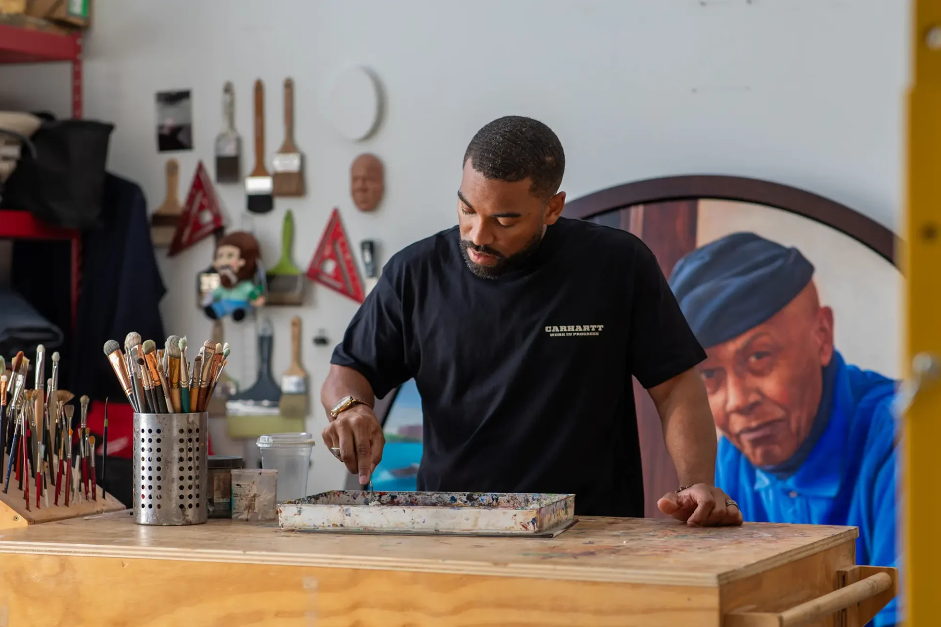 Mario Moore painting in his studio in Detroit, Michigan.