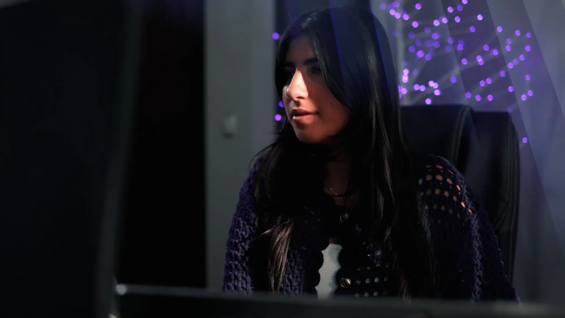Annabelle Saco sitting at a desk editing a video on a computer