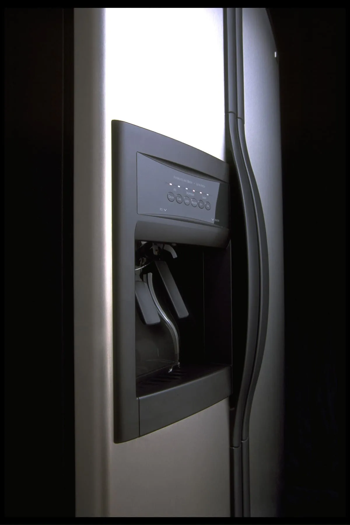 A stainless steel refrigerator front with an ice and water dispensor