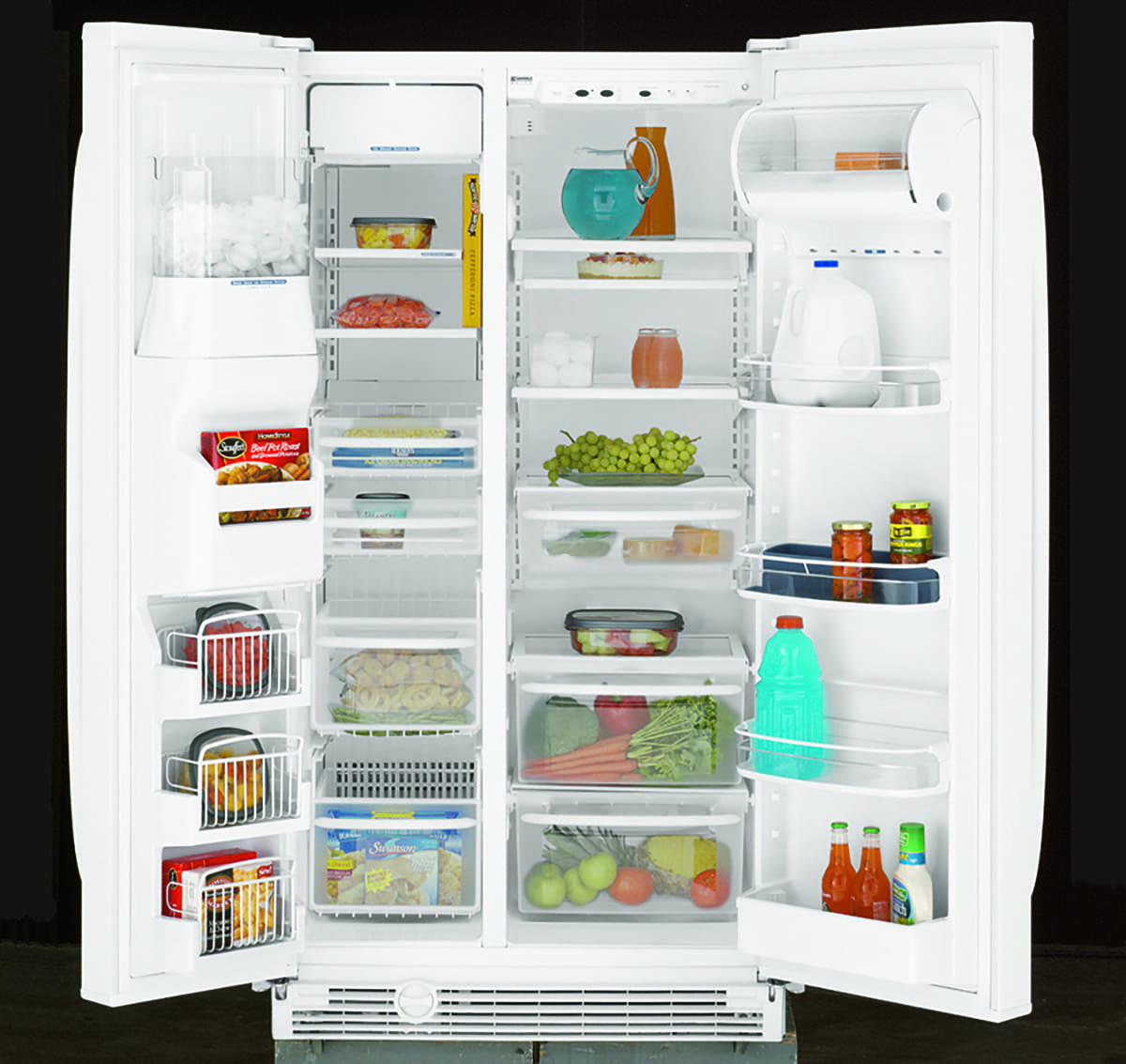 A two door white refrigerator open to show shelving and food.