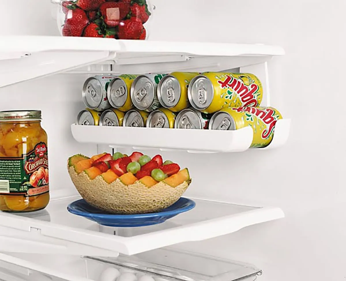 A refrigerator shelving that shows a soda can holder.