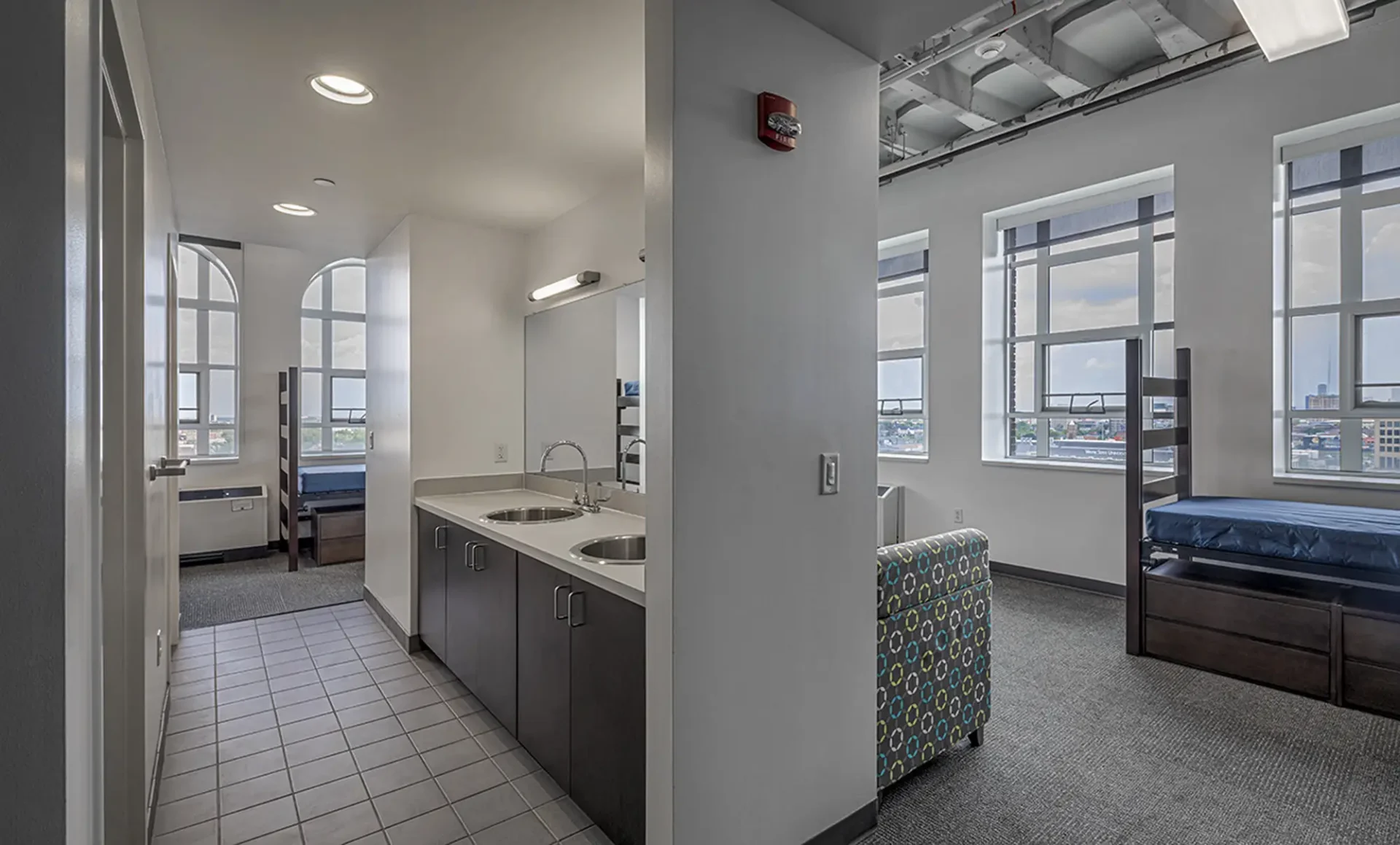 Interior shot of a dorm at the Taubman Center. You can the sink in the kitchen, some beds and a closet