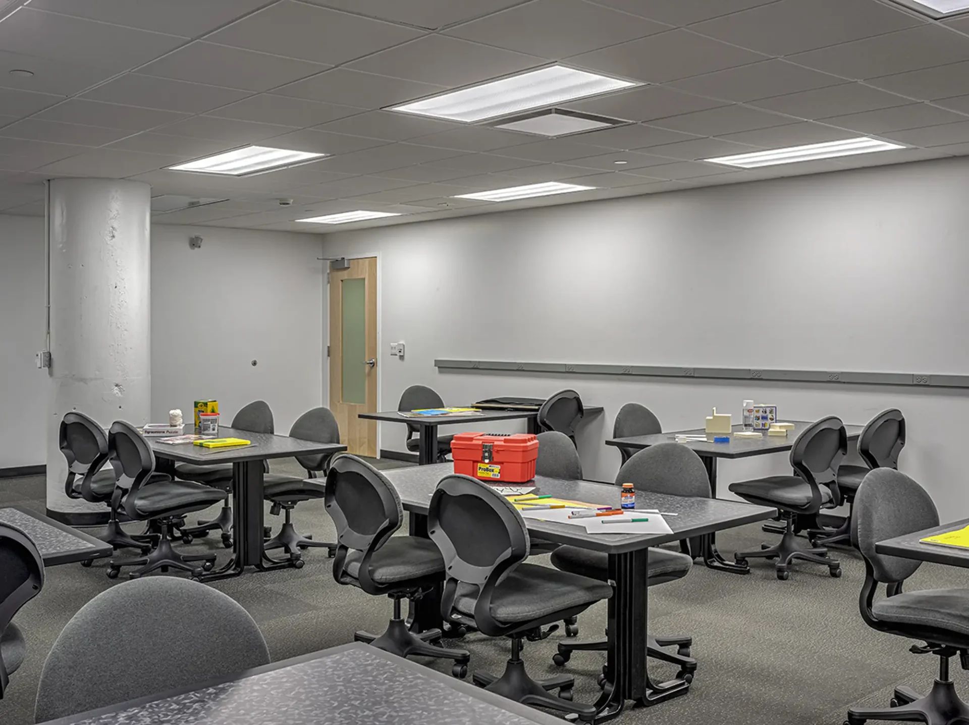 Interior shot of a dorm at the Taubman Center. It's a work area with multiple tables and chairs