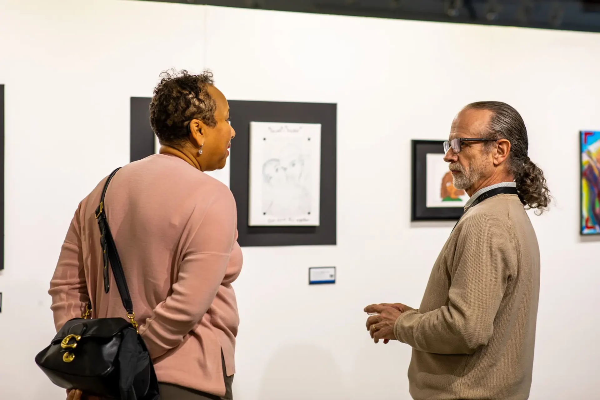 Two people speaking at a gallery