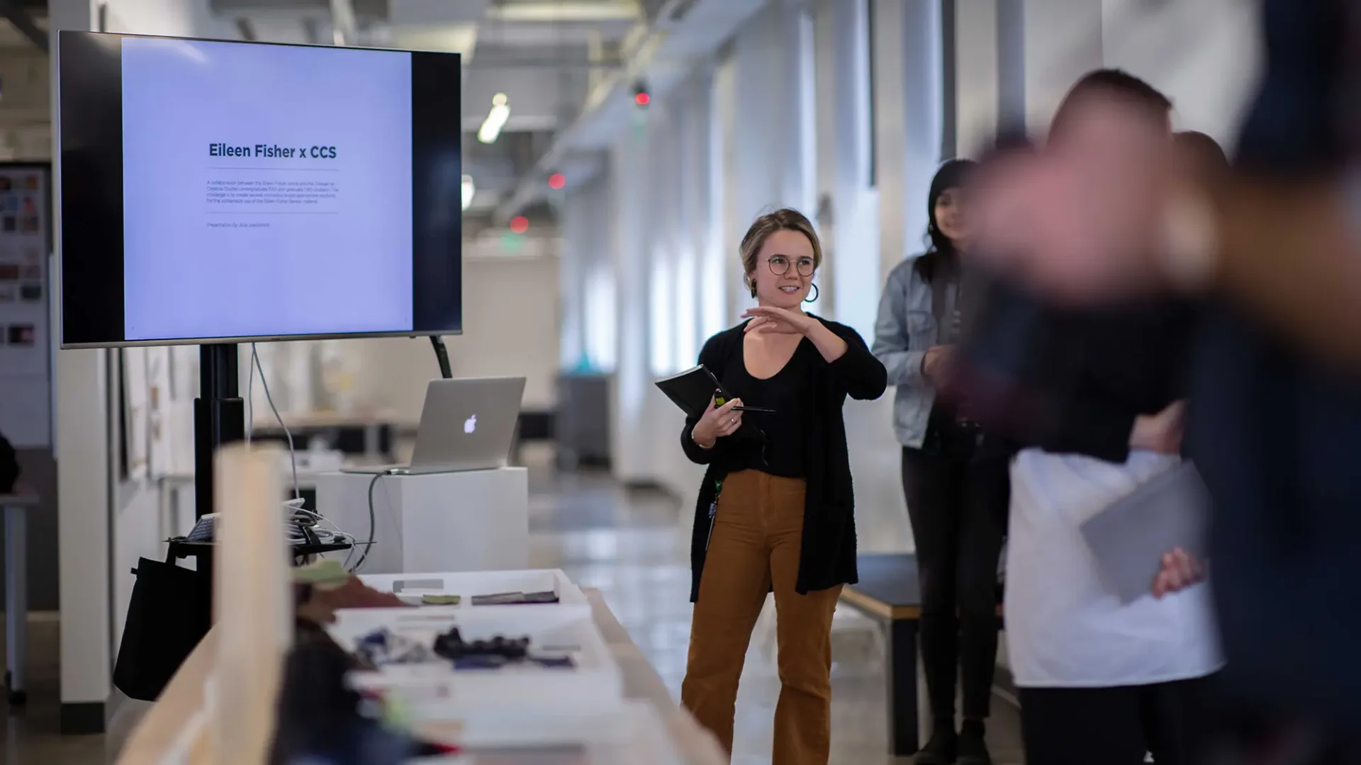 A student presenting Eileen Fisher x CCS on a digital screen