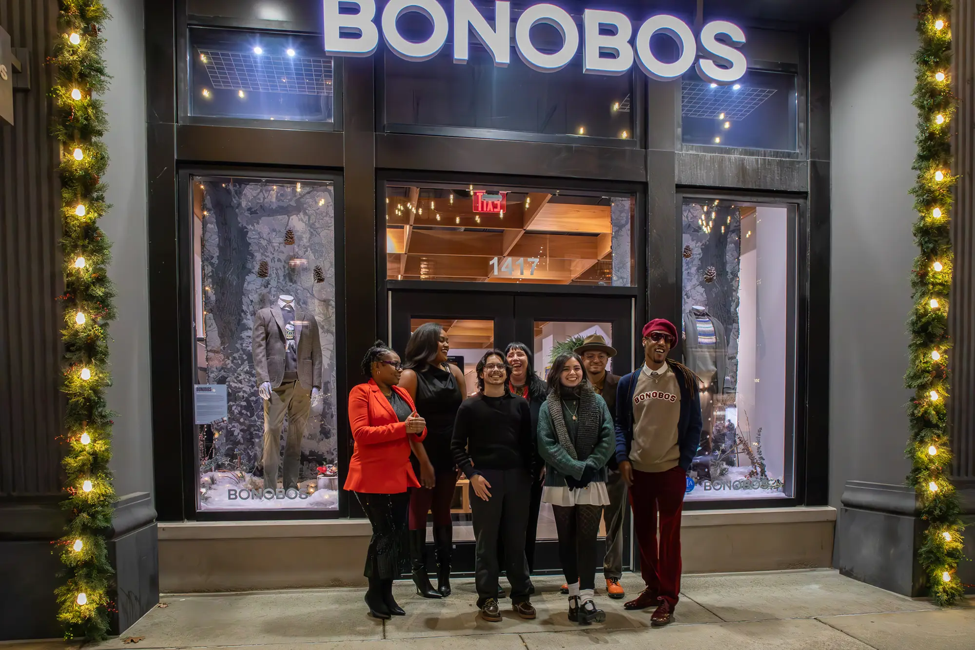 A group of students posing for a picture outside of their winter display at Bonobos