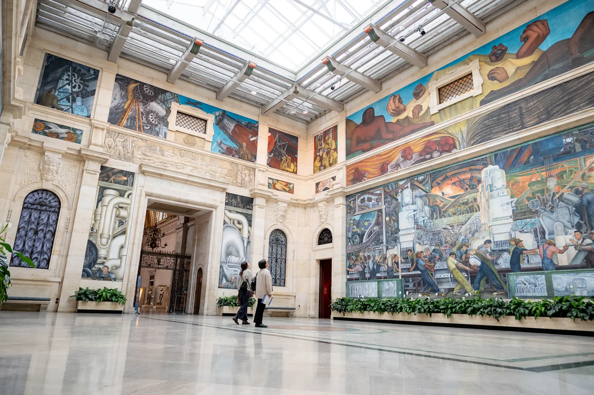 People looking at the murals inside DIA