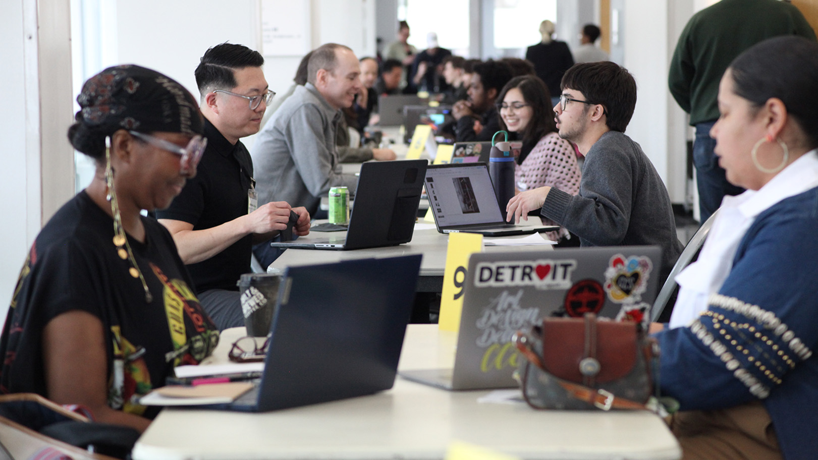 Film, Photo, and Interdisciplinary students sitting at a long row of tables having portfolio reviews with industry professionals during an Industry Day