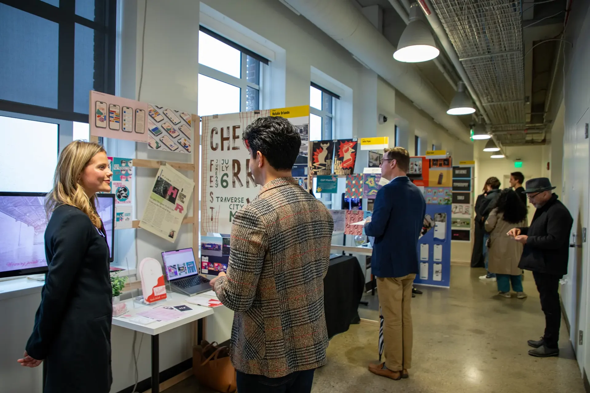 Students walking and talking around boards during industry day