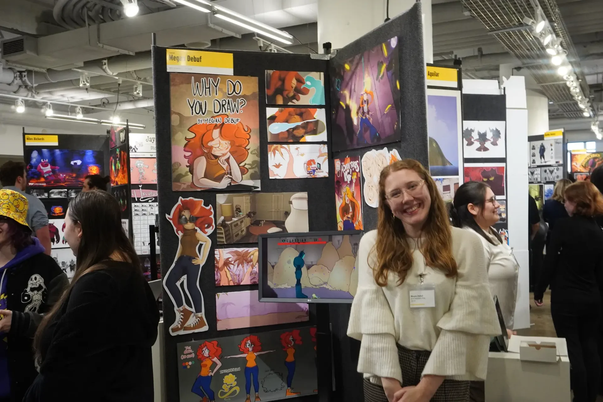 A student smiling standing in front of their board at Animation's Industry Day
