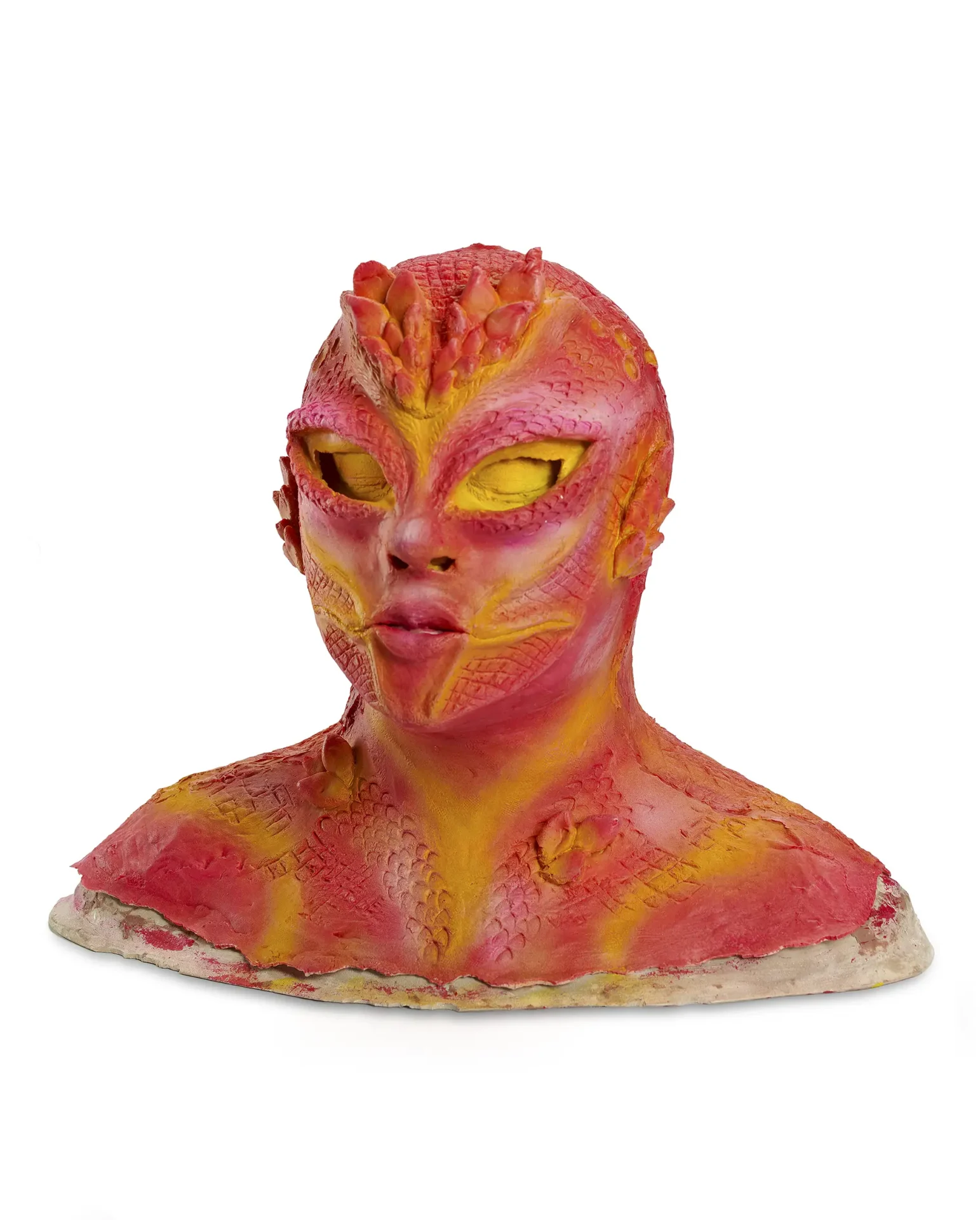 SFX latex face mask of a scaly, feminine sea creature, painted orange, pink, and goldenrod.