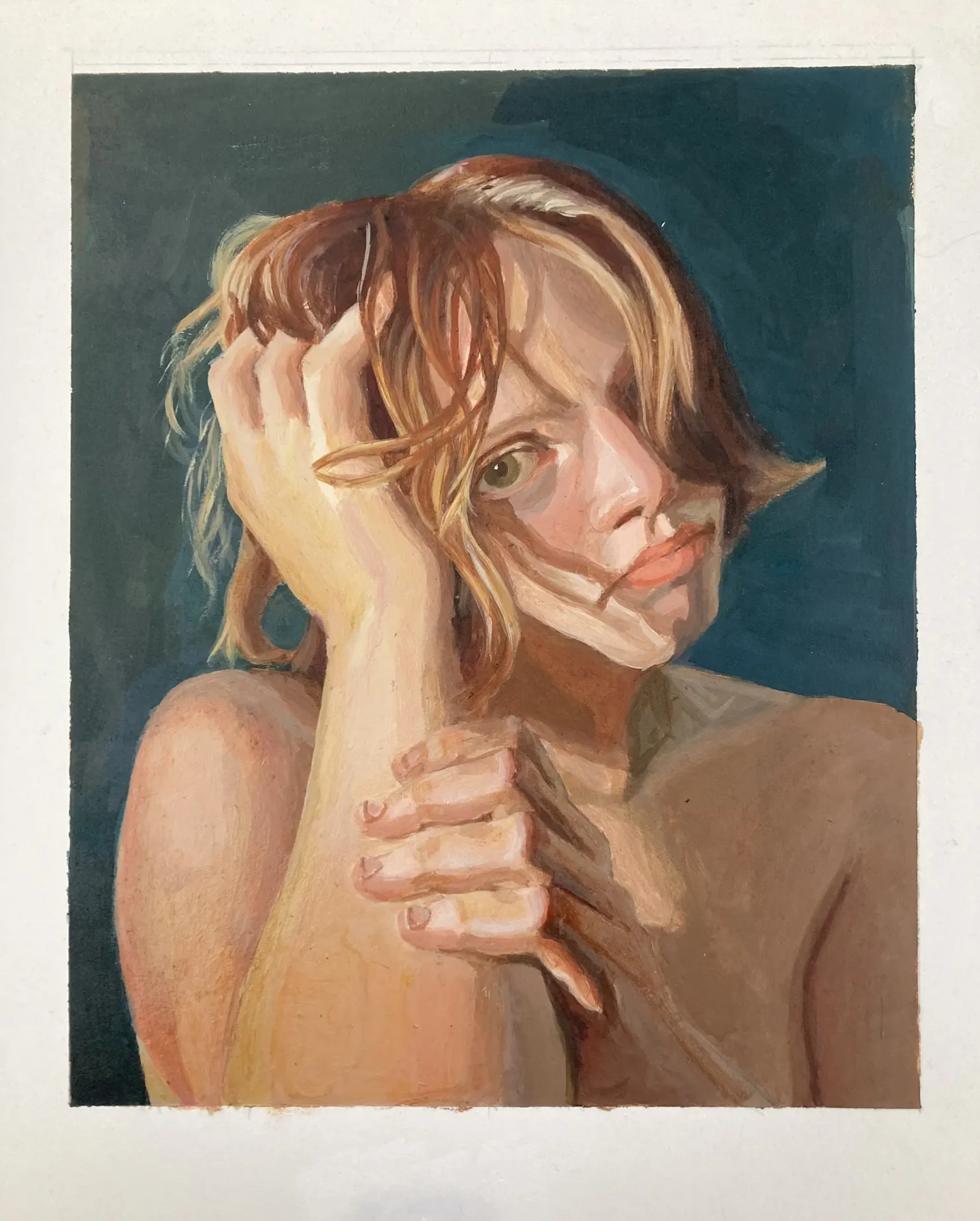 Portrait of a young woman hiding behind her arms.