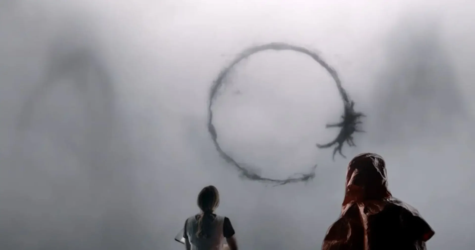2 people staring off into a smokey, foggy background with a dark smoke circle appearing