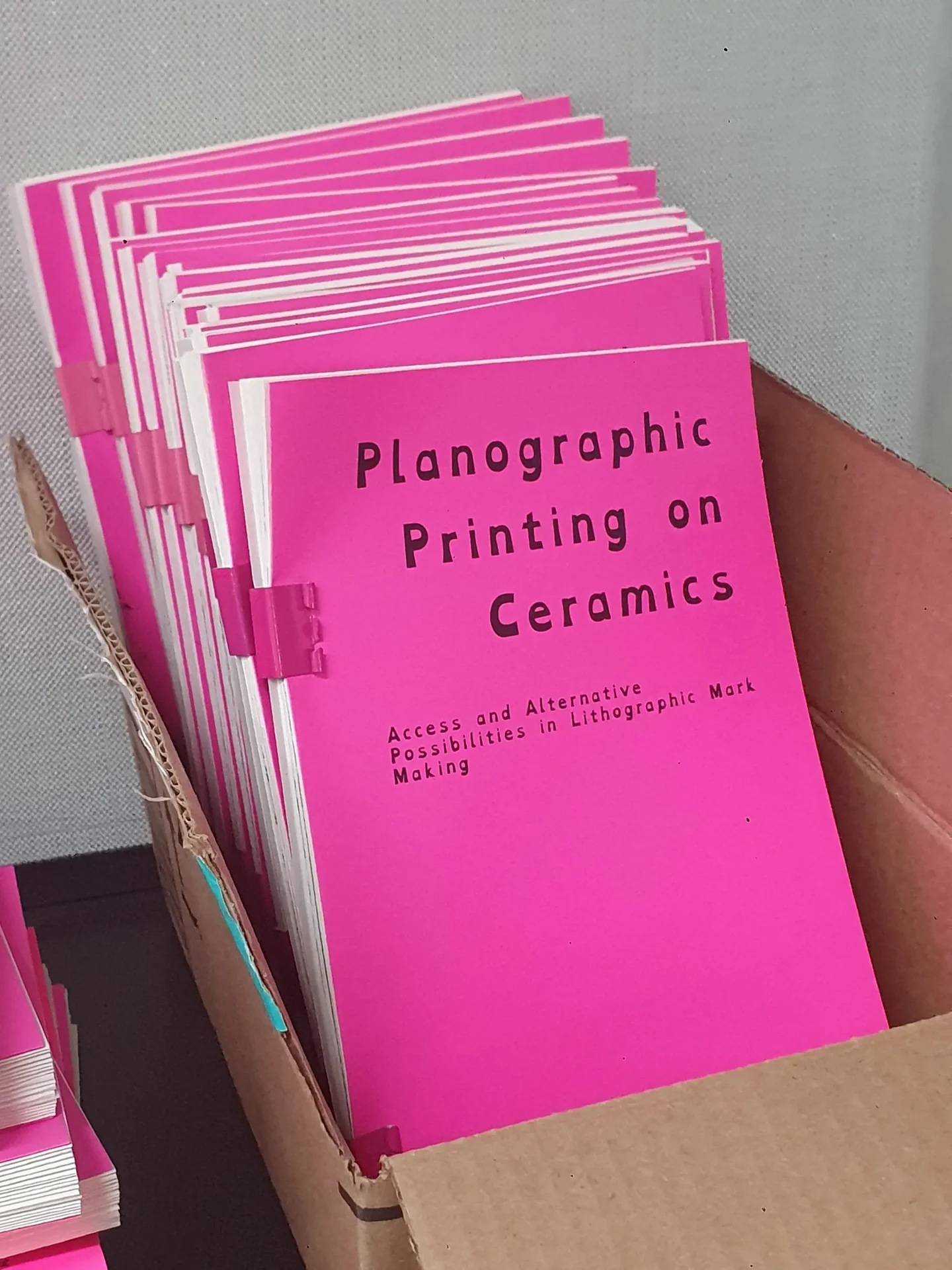 Copies of thesis publication being prepped for exhibition.