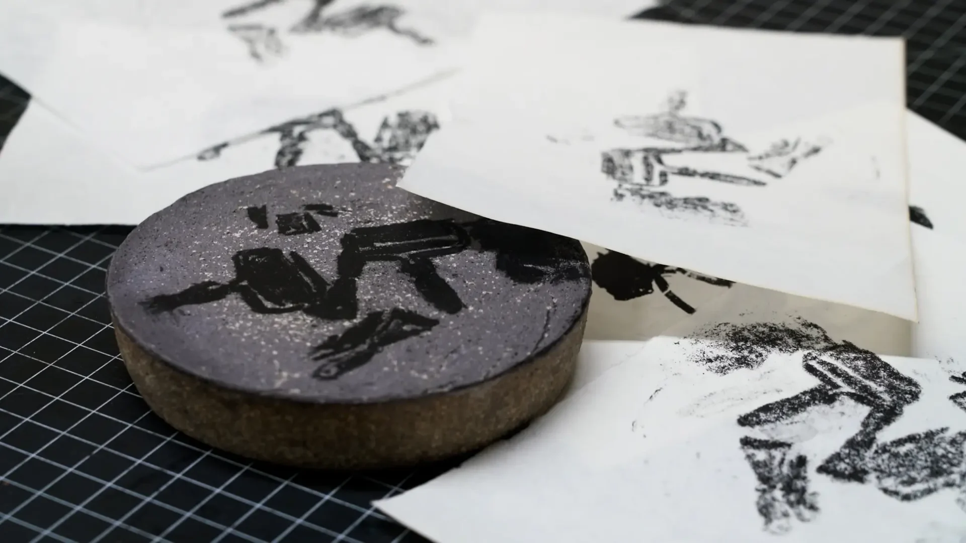 Film still from thesis process film; close-up of litho test print depicting printmaking brayers