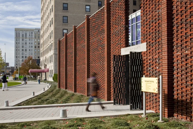 A student walking into the Yamasaki building on the Ford campus
