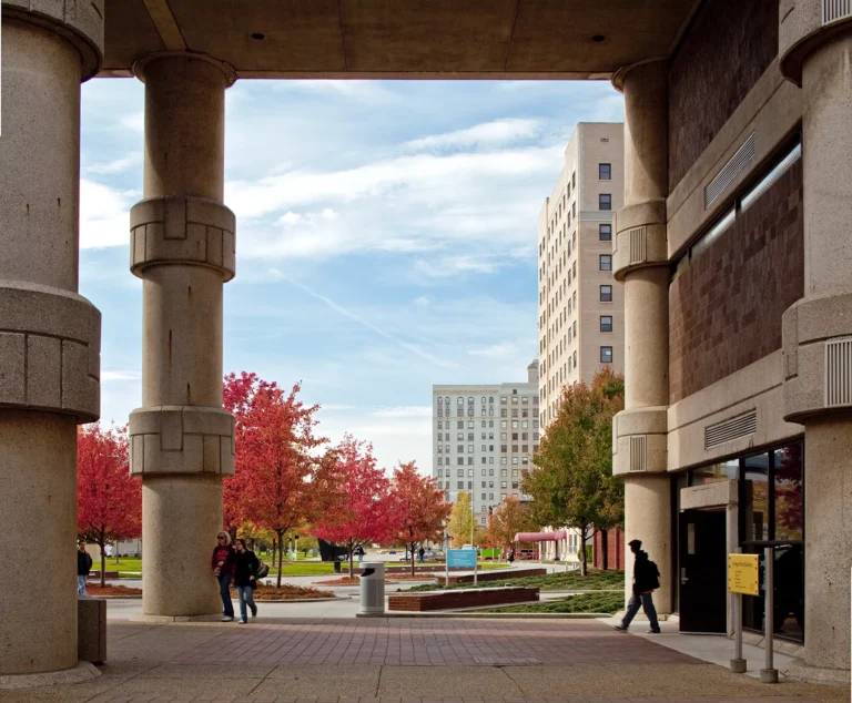 Students walking under the roof of a building on the Ford campus