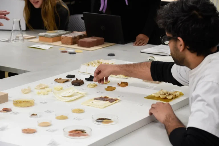 A student reaching for something on a materials board