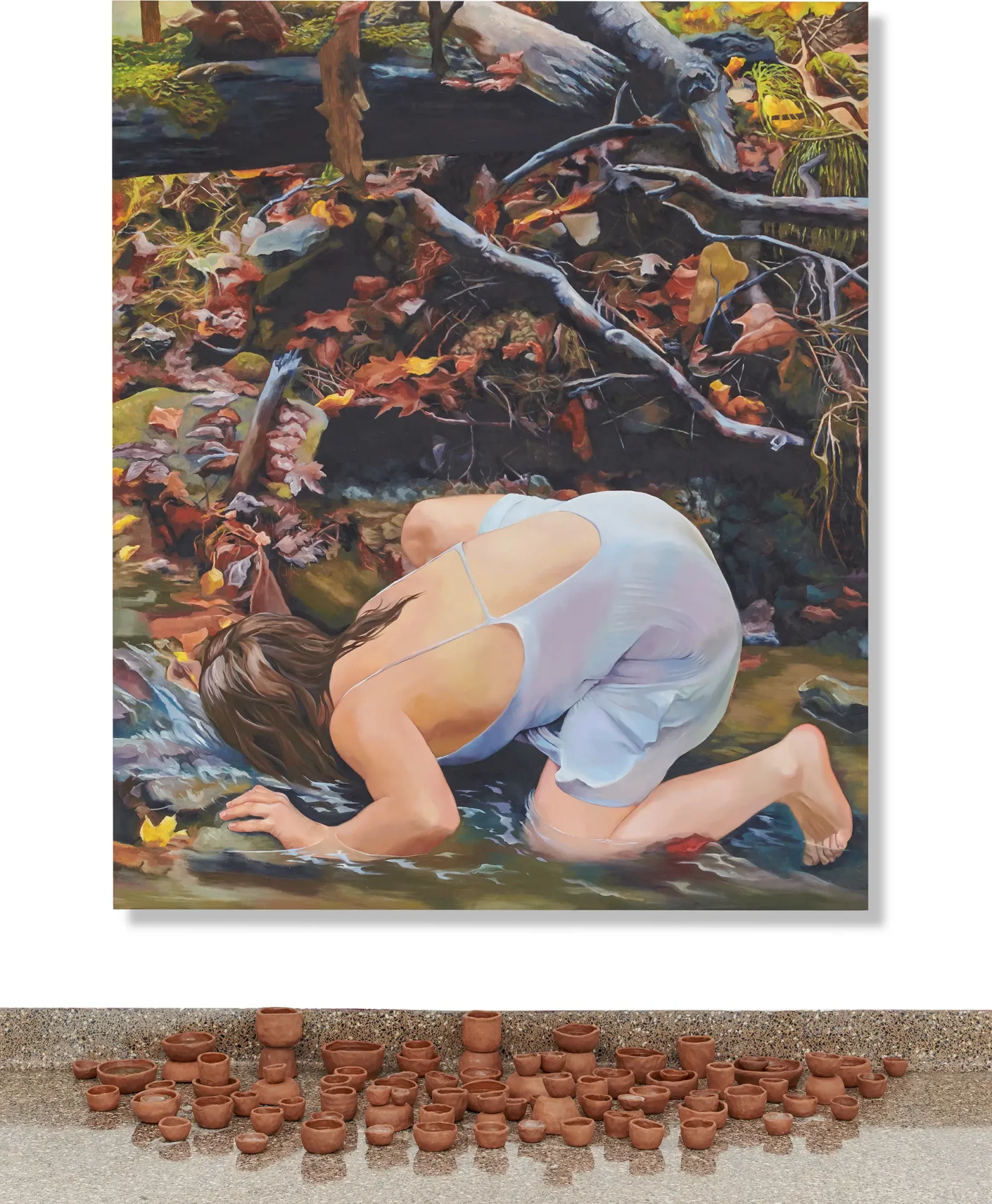 Painting of woman drinking water from a river with a pinch pots in front of it