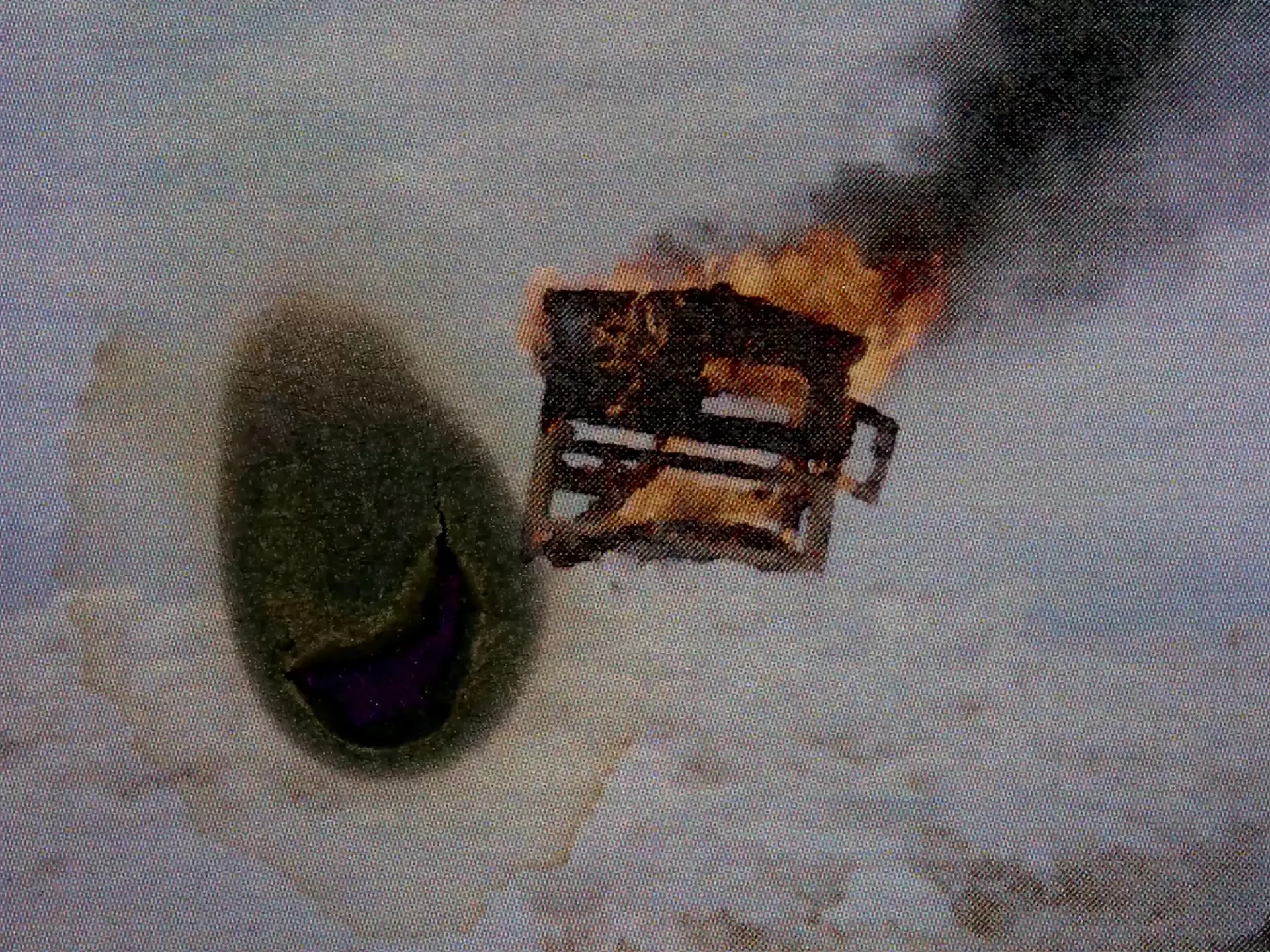 Film still from Super8 short: Composite image—a burning chicken superimposed over handpainted abstraction.