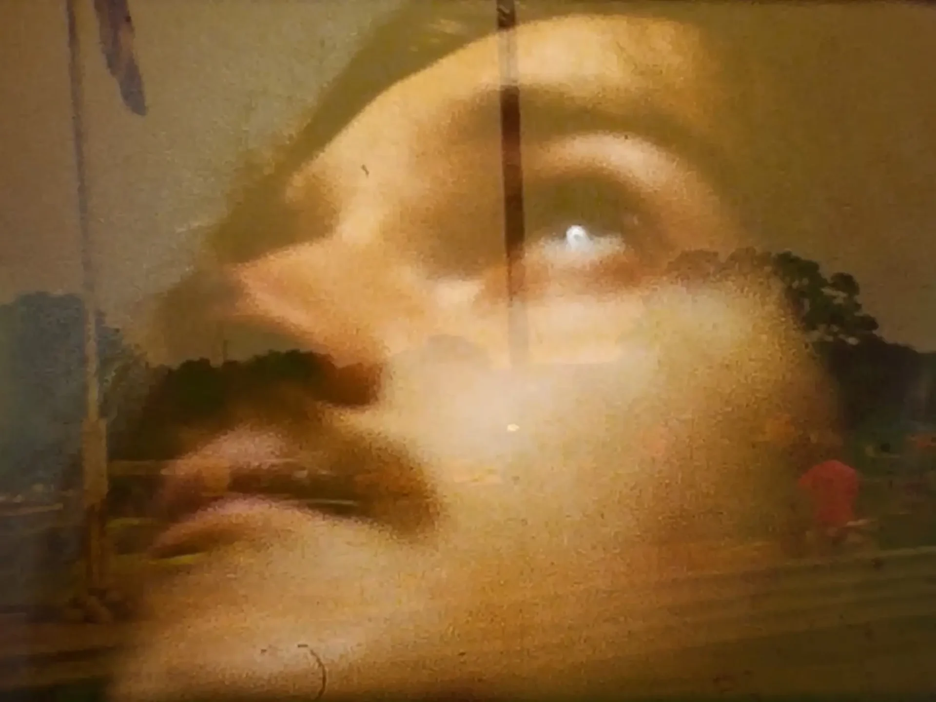 Film still from Super8 short: Composite image—closeup of a face superimposed over a public park.