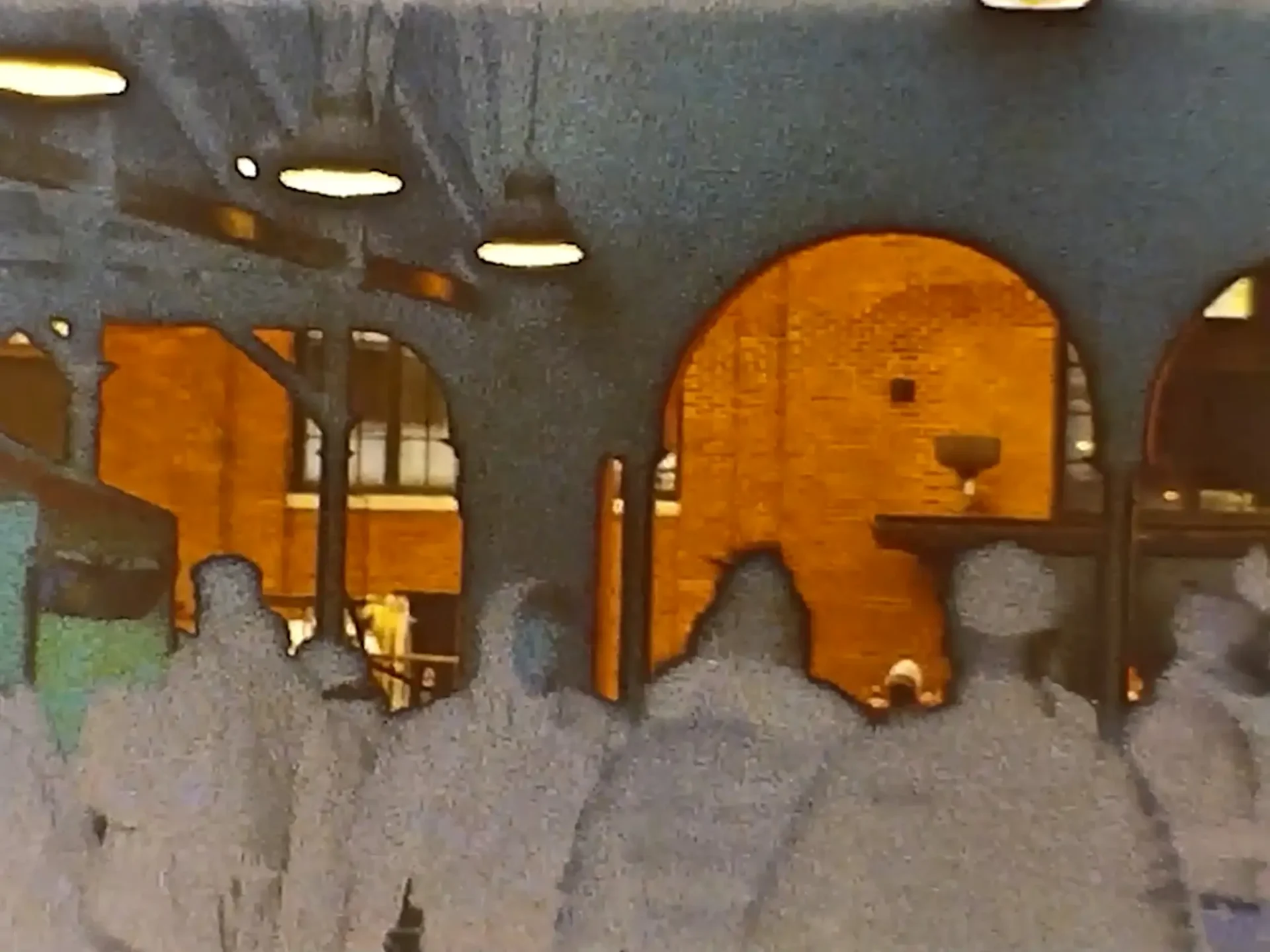 Film still from Super8 short: Solarized image of a group of people silhoutted by in the arches of Eastern Market.