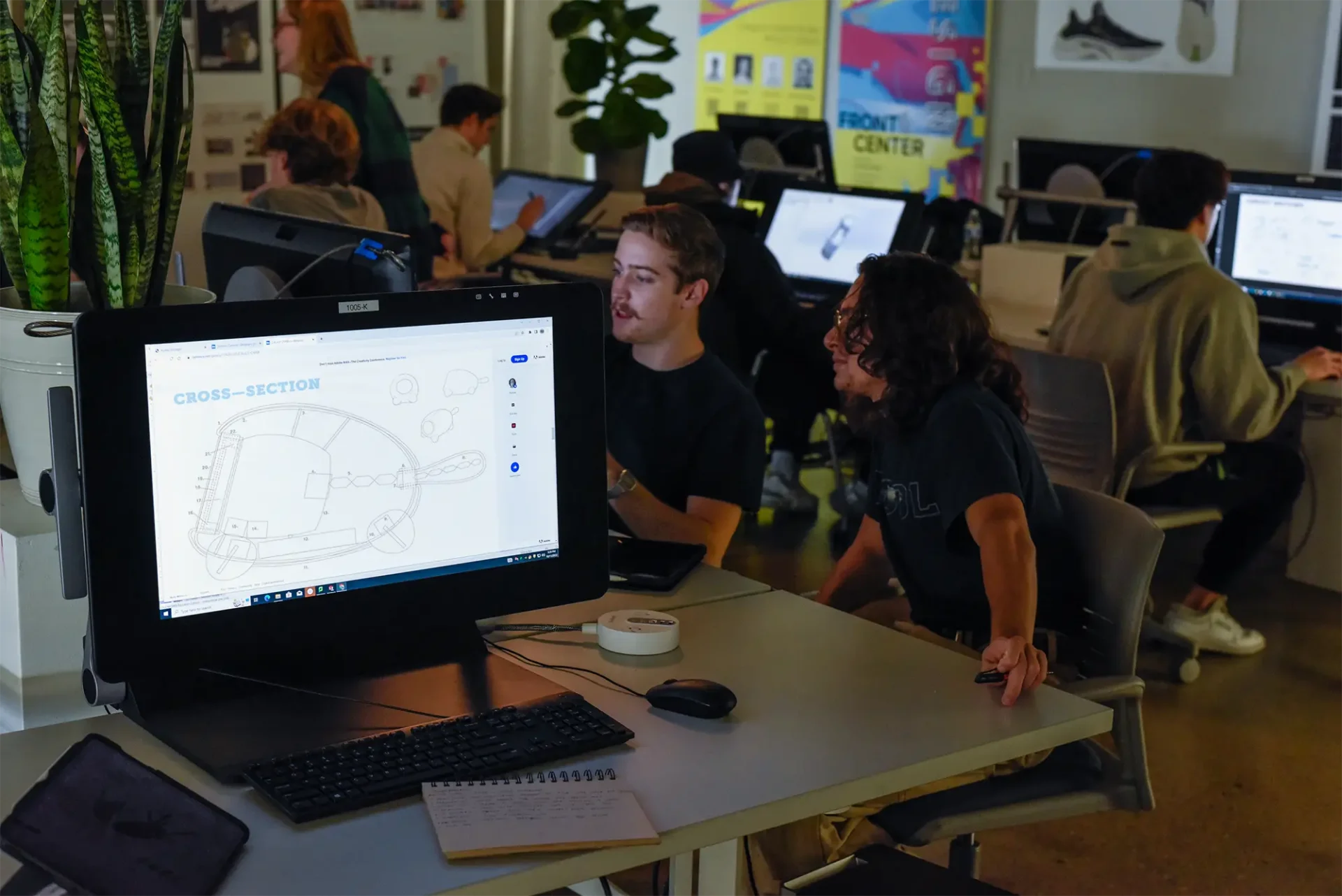 Students working at a computer in a lab setting