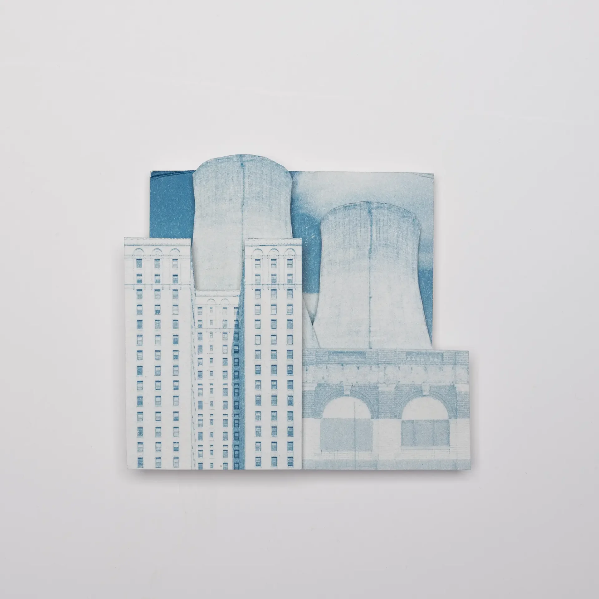 Architectural cyanotypes collaged to make new a new environment with skyscapers and nuclear power.