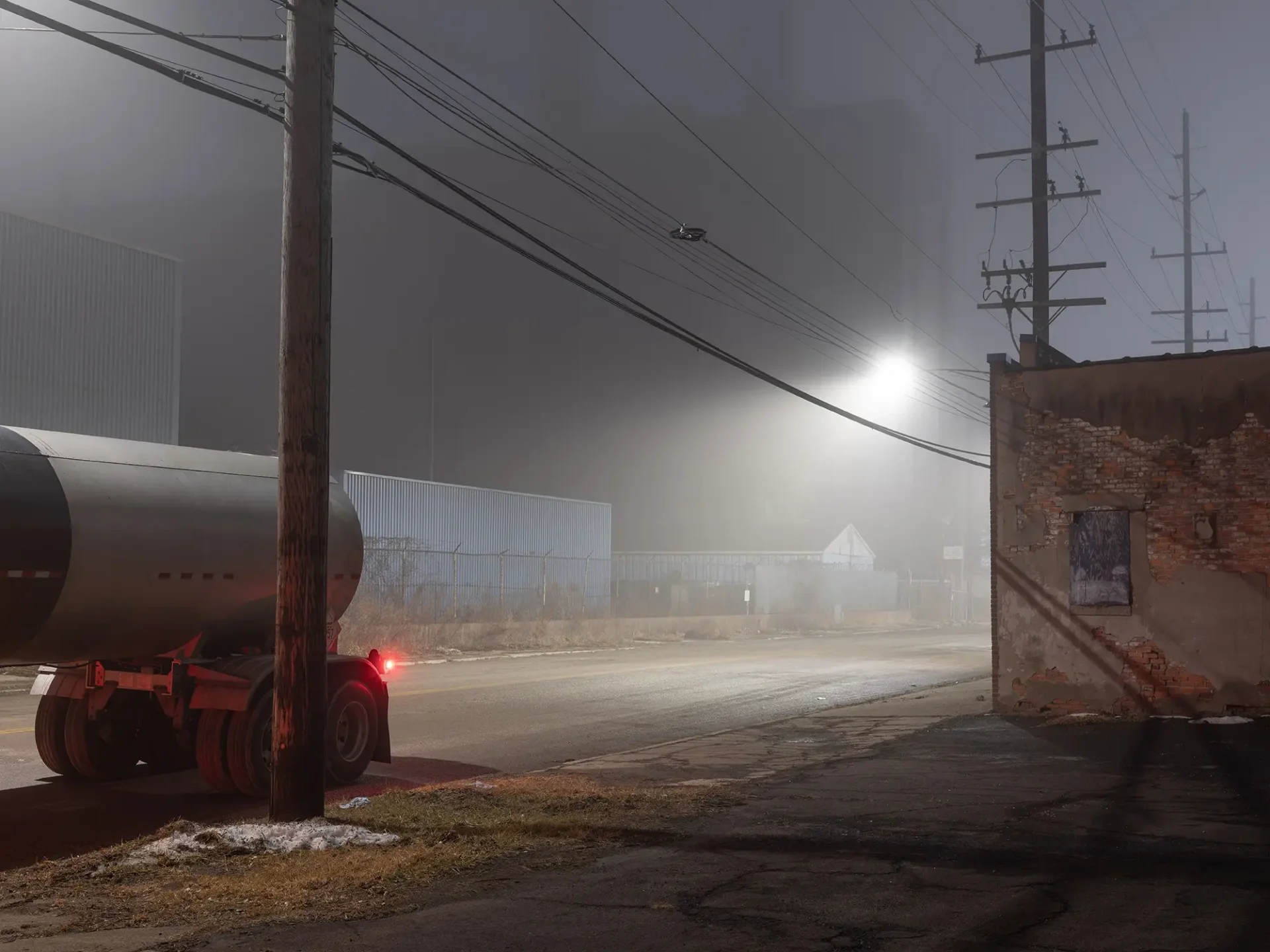 Industrial area with a tanker at night.