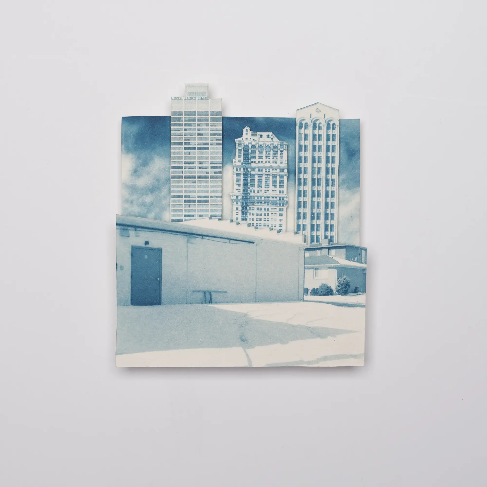 Architectural cyanotypes collaged to make new a new environment combining urban and suburban structures.