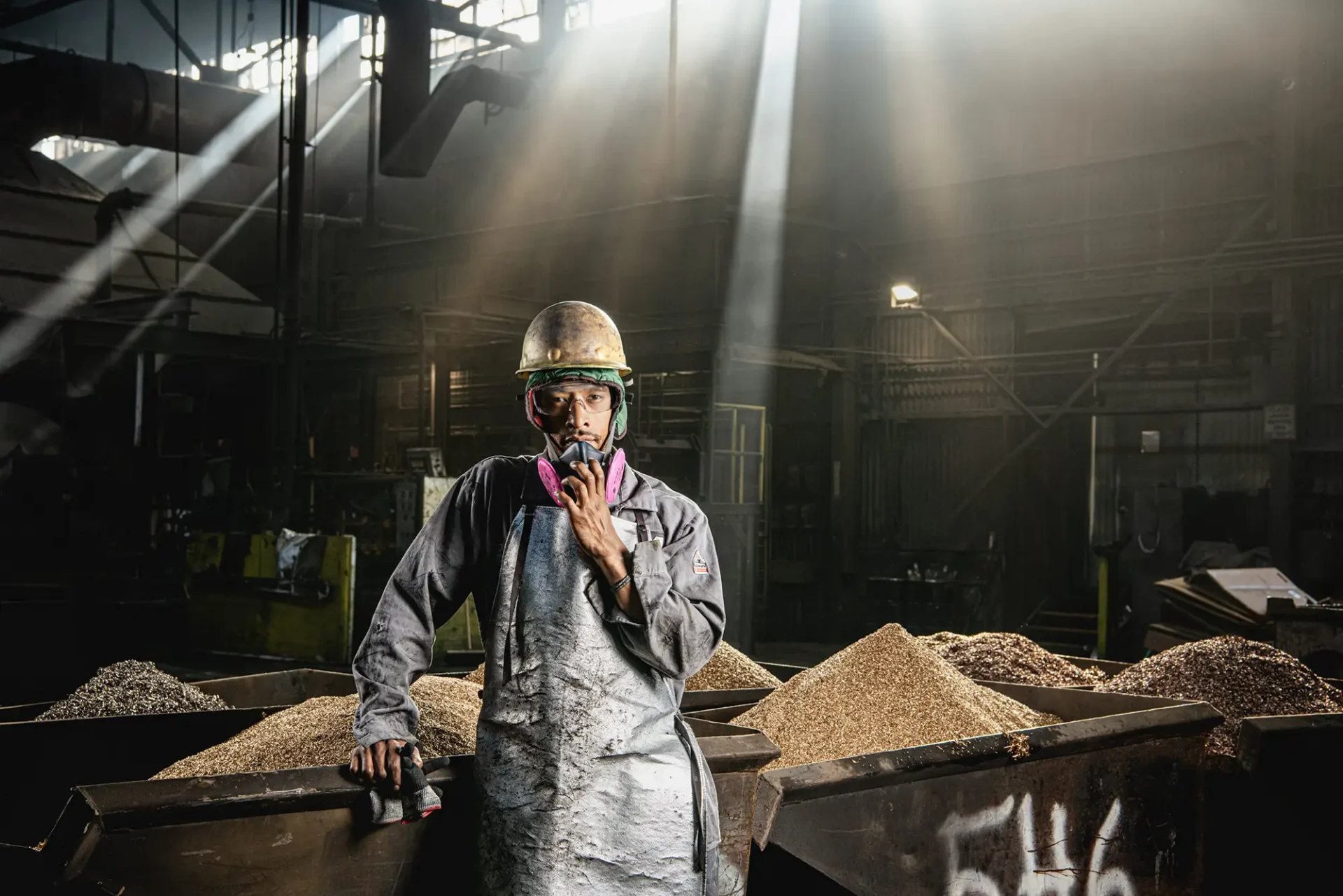 Environmental portrait of a Metalworker in a factory, posing for a portrait.