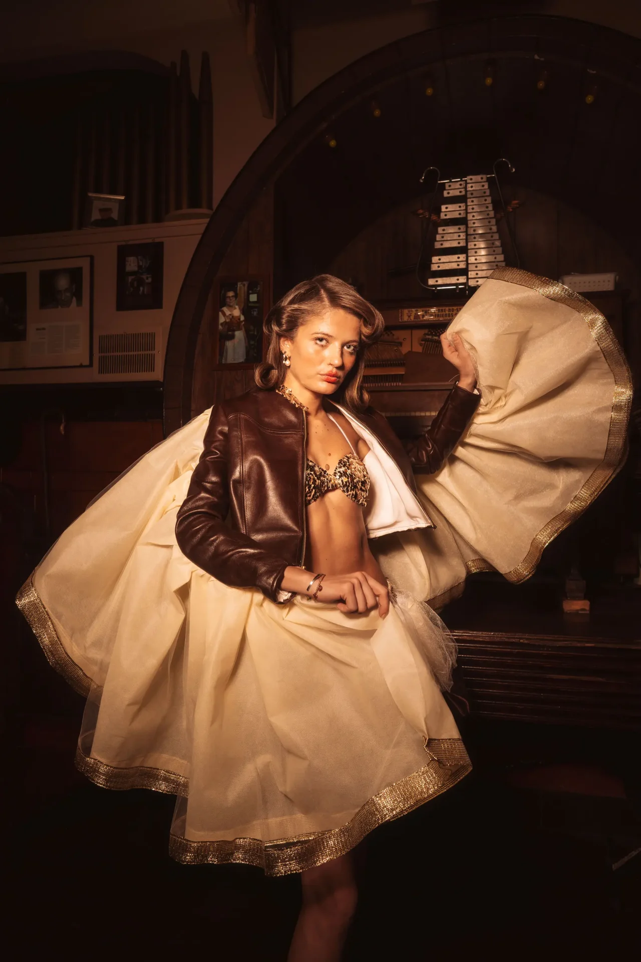 Model wearing leather jacket with gathered fabric seam detail