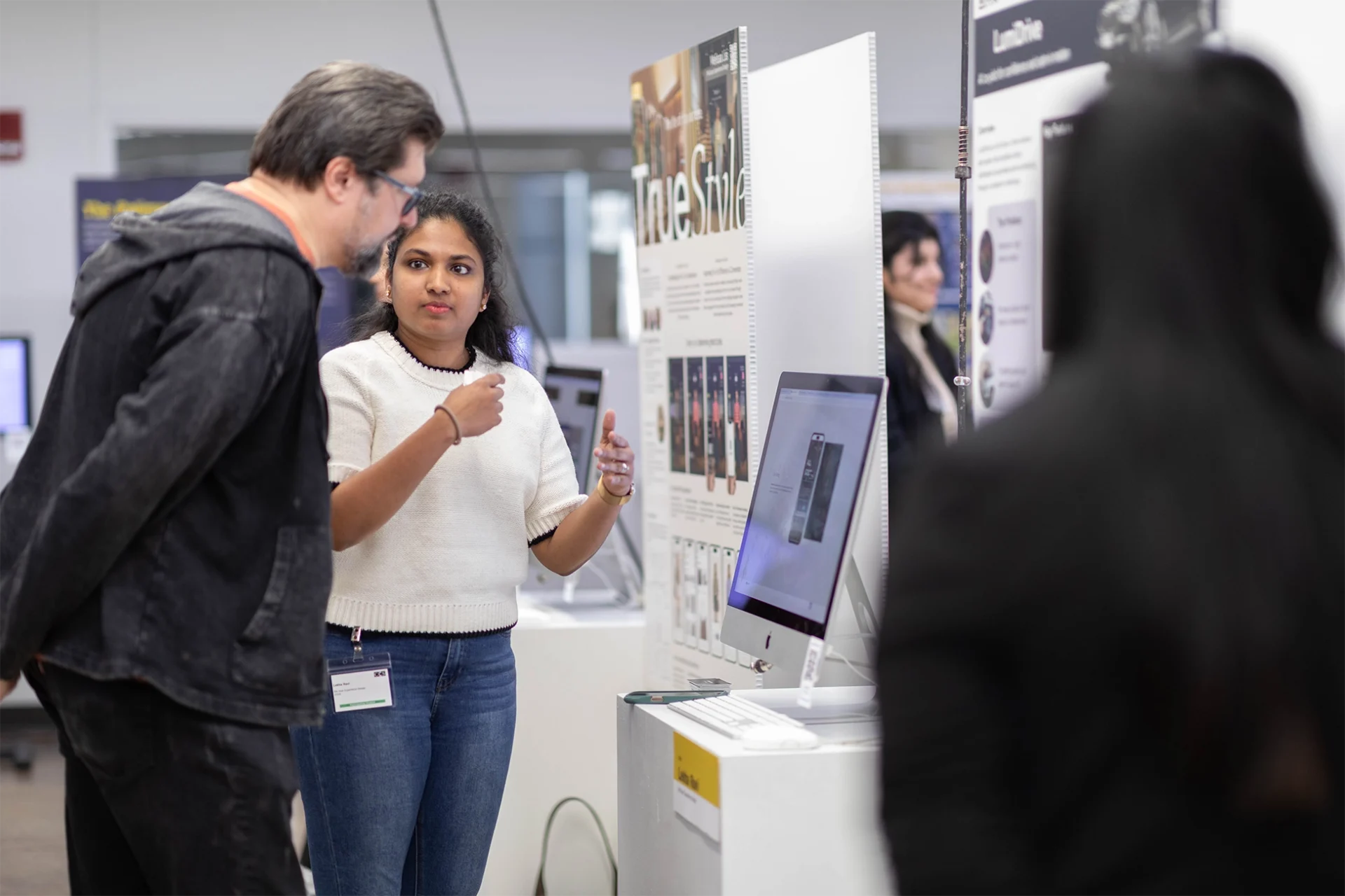 A CCS student showcases work and speaks to an industry professional at a CCS Industry Day Event.