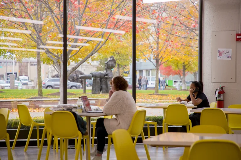 Students working at tables inside the cafe