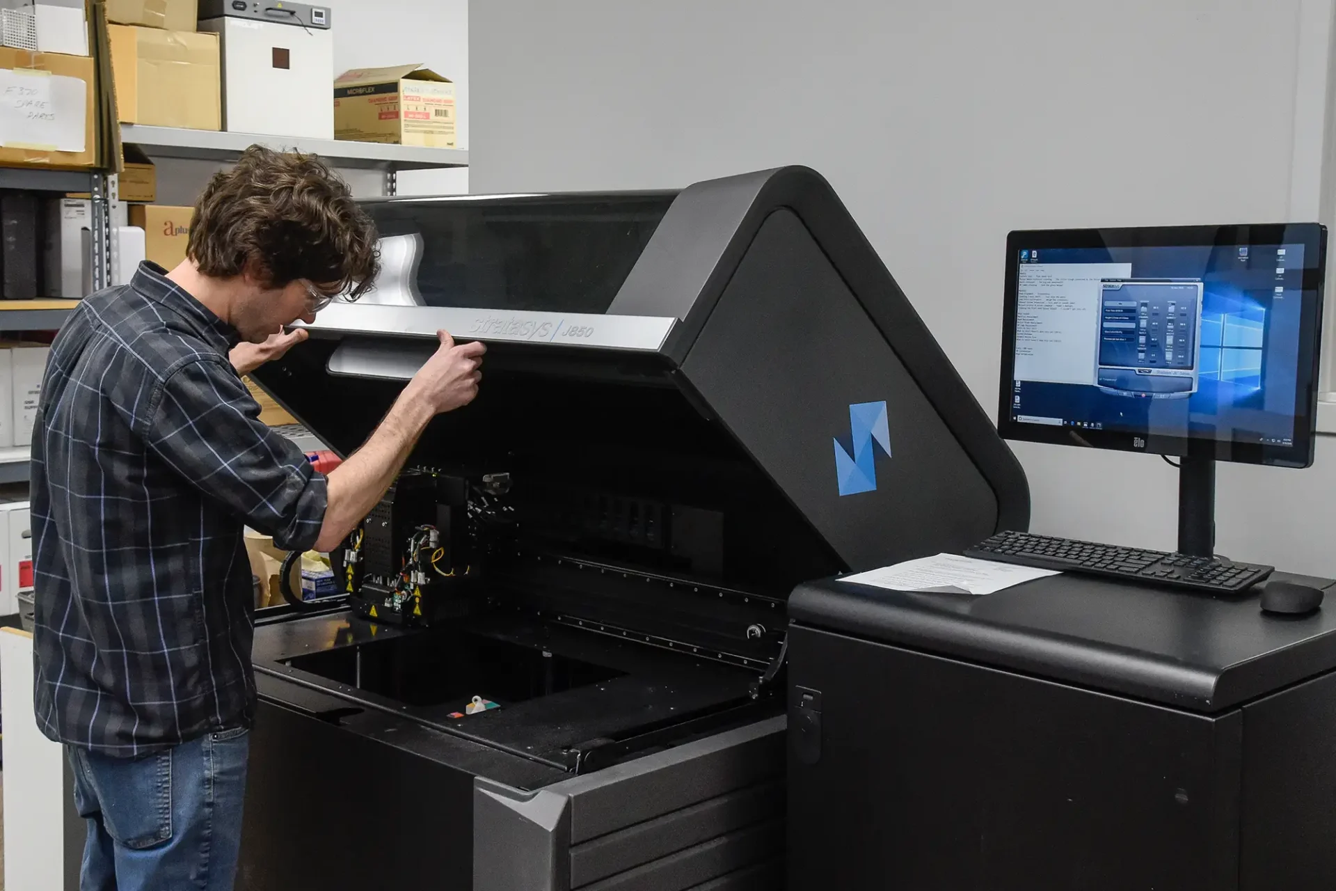 A student working on a 3D printer