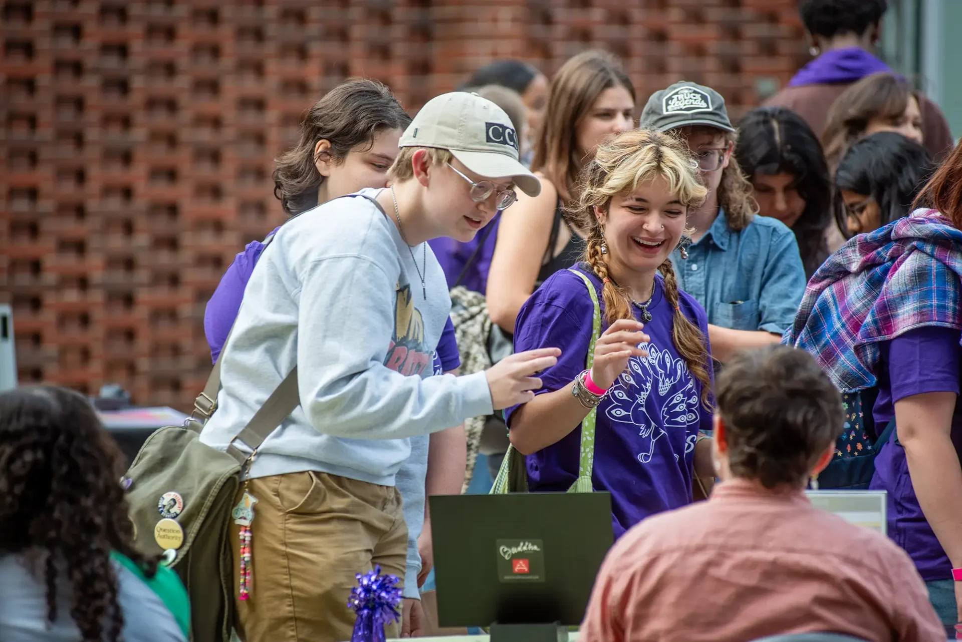 A group of students smiling and enjoying a conversation outside
