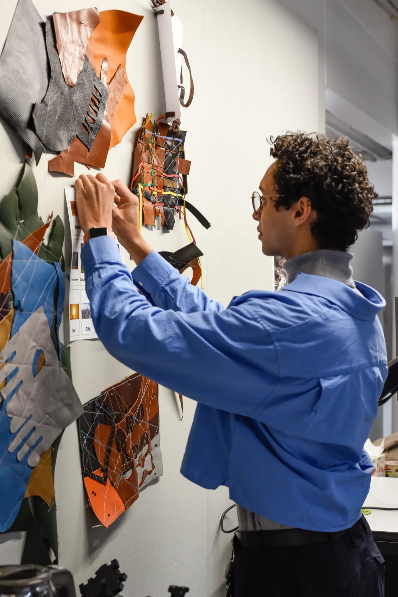 Design for Sustainability student pinning material samples to wall