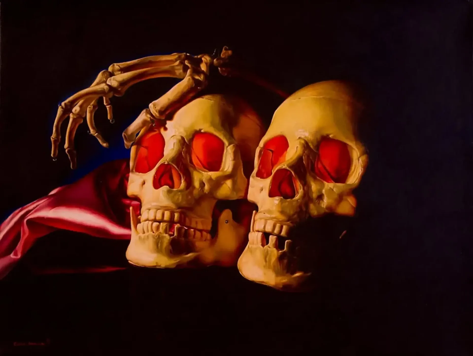 two skulls with a hand on top of one of them