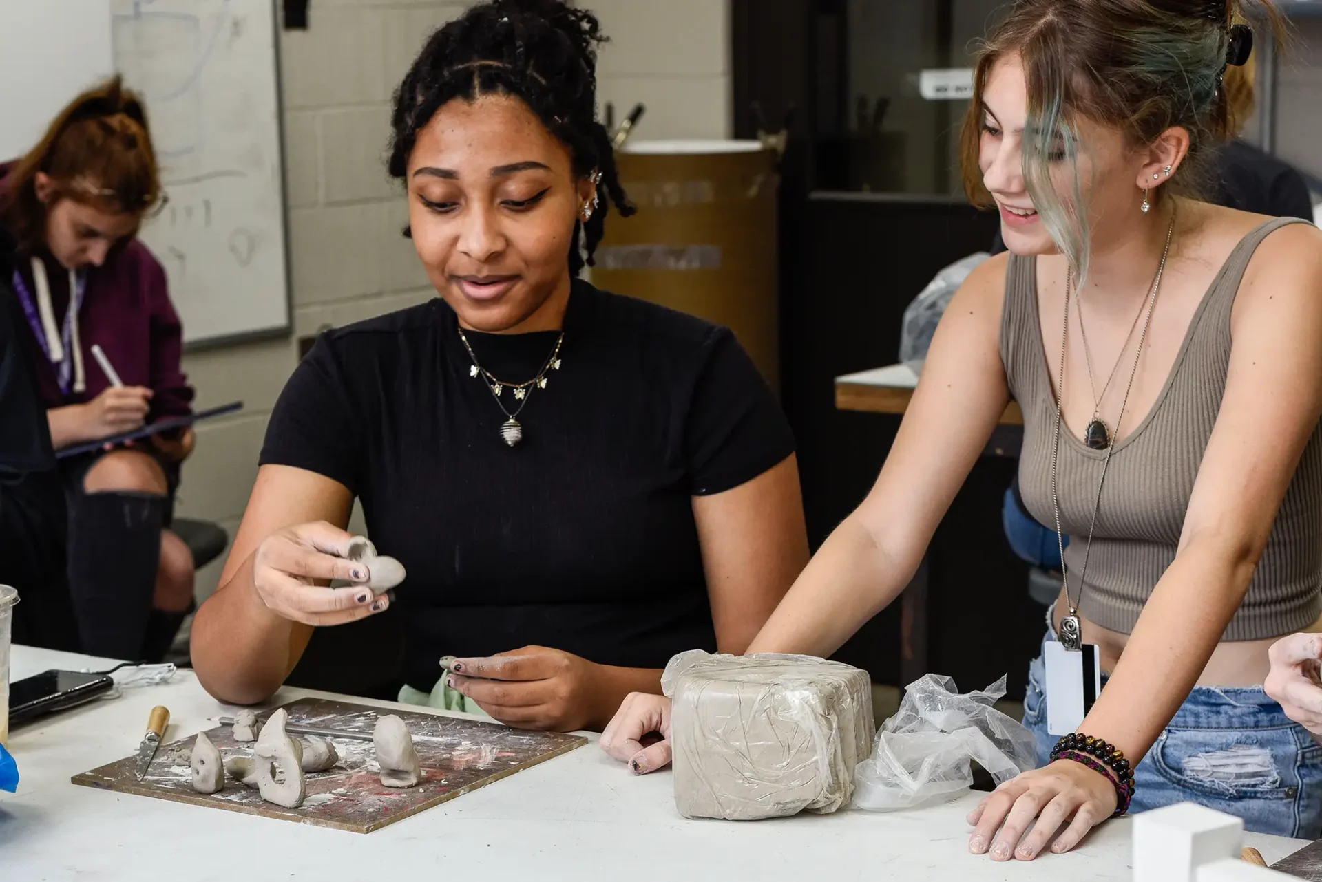Students working on small clay projects.