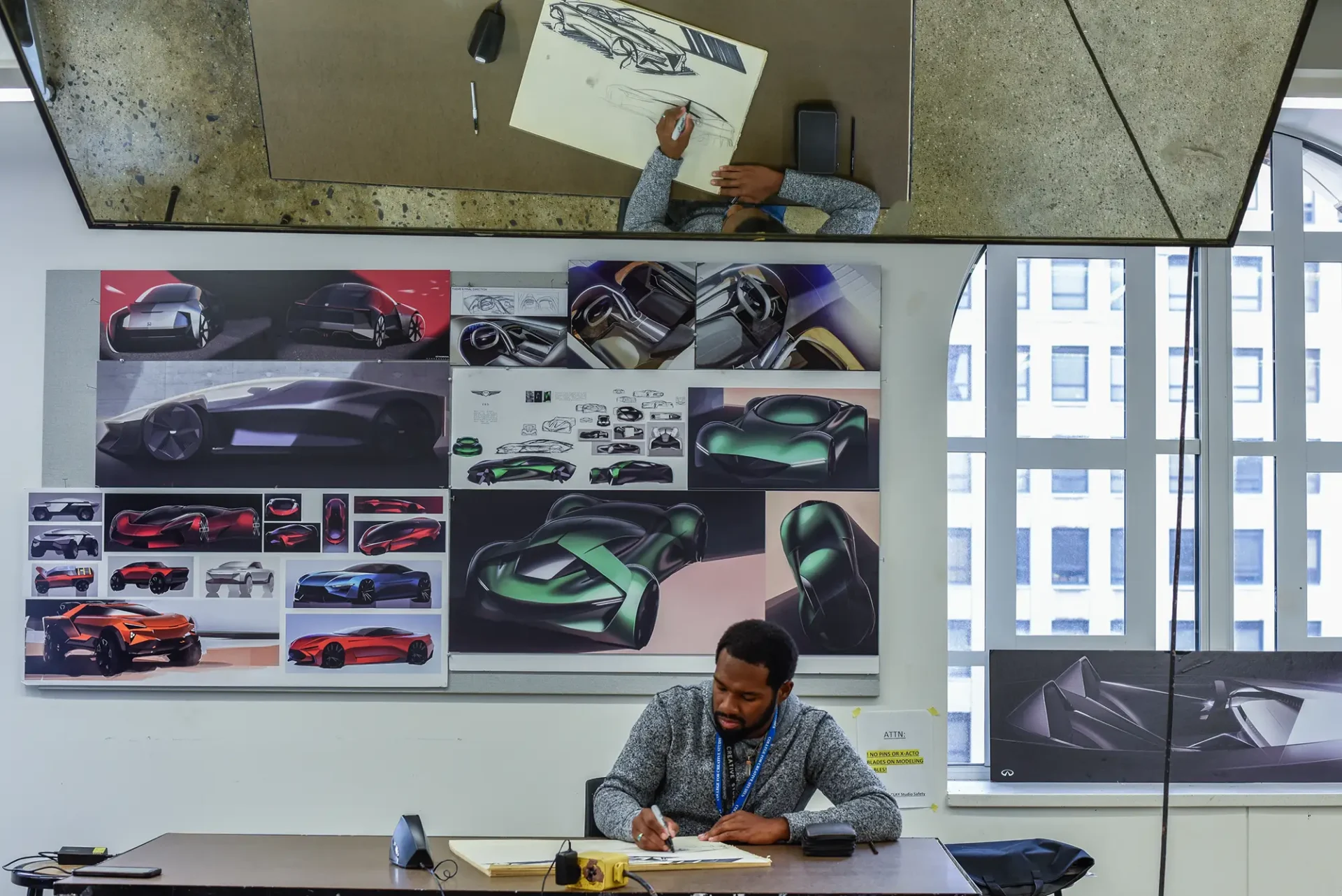 Student drawing a vehicle in a Transportation Design studio