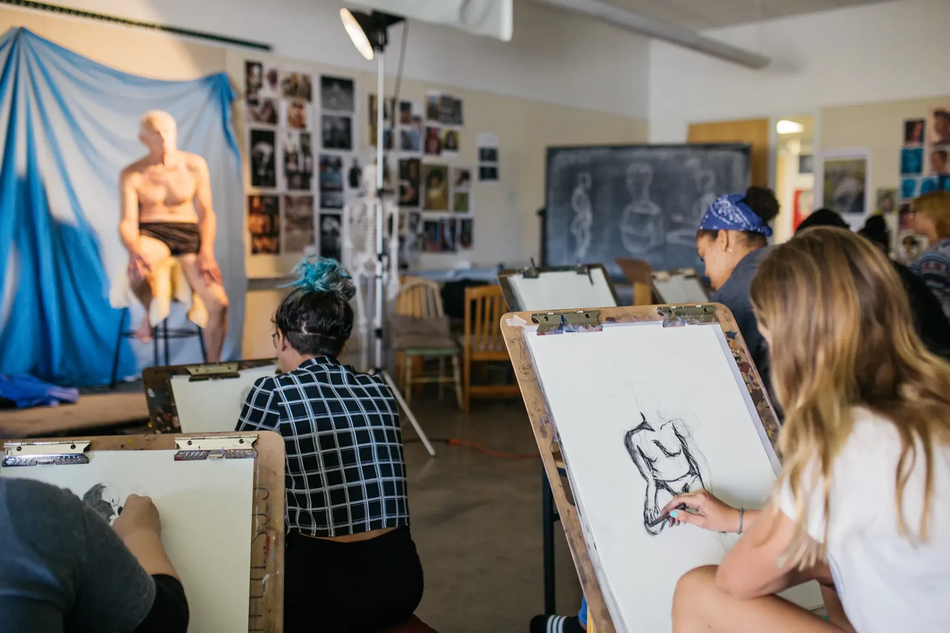 Classroom of precollege students drawing a figure