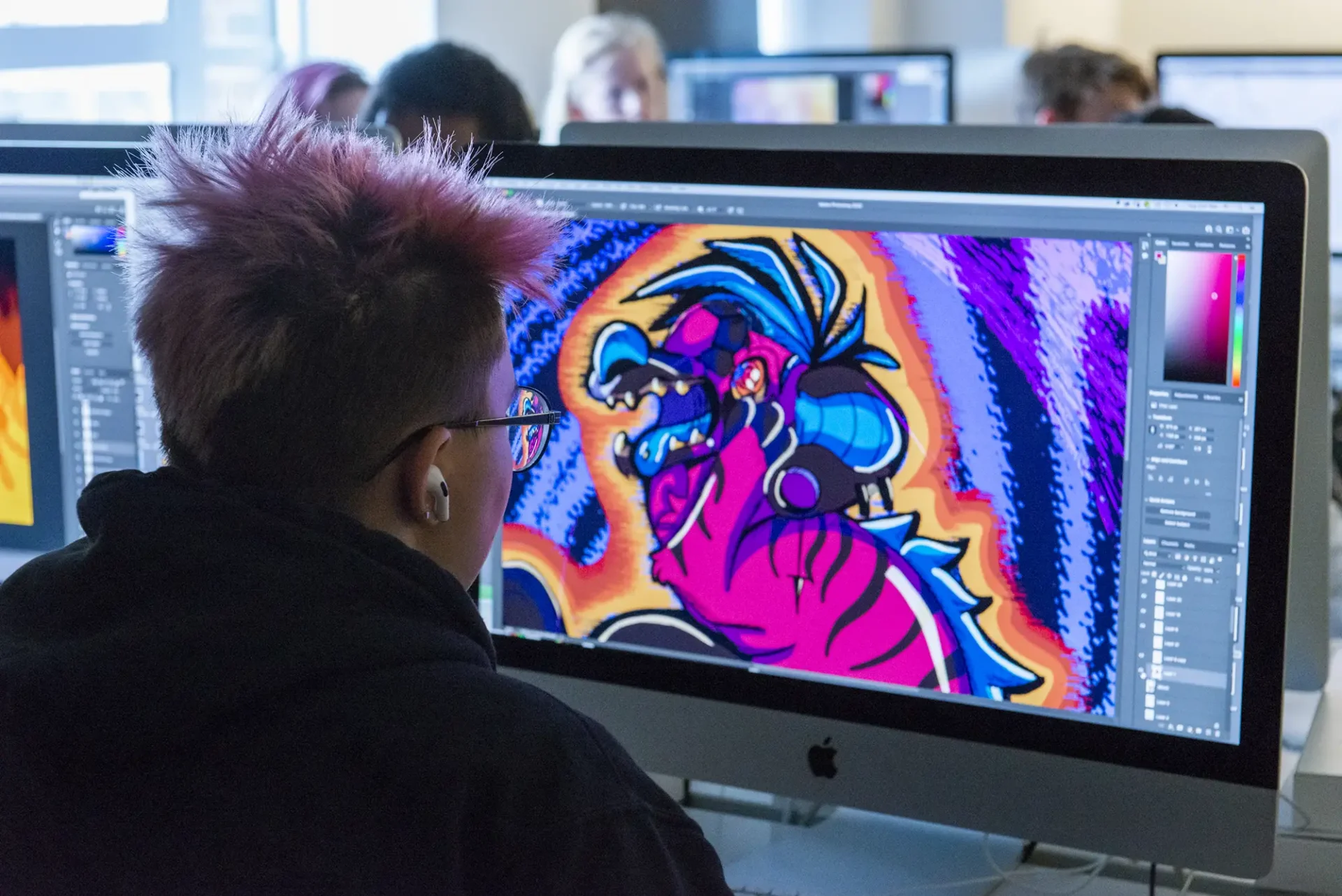 Teen Precollege student creating a digital illustration on the computer.