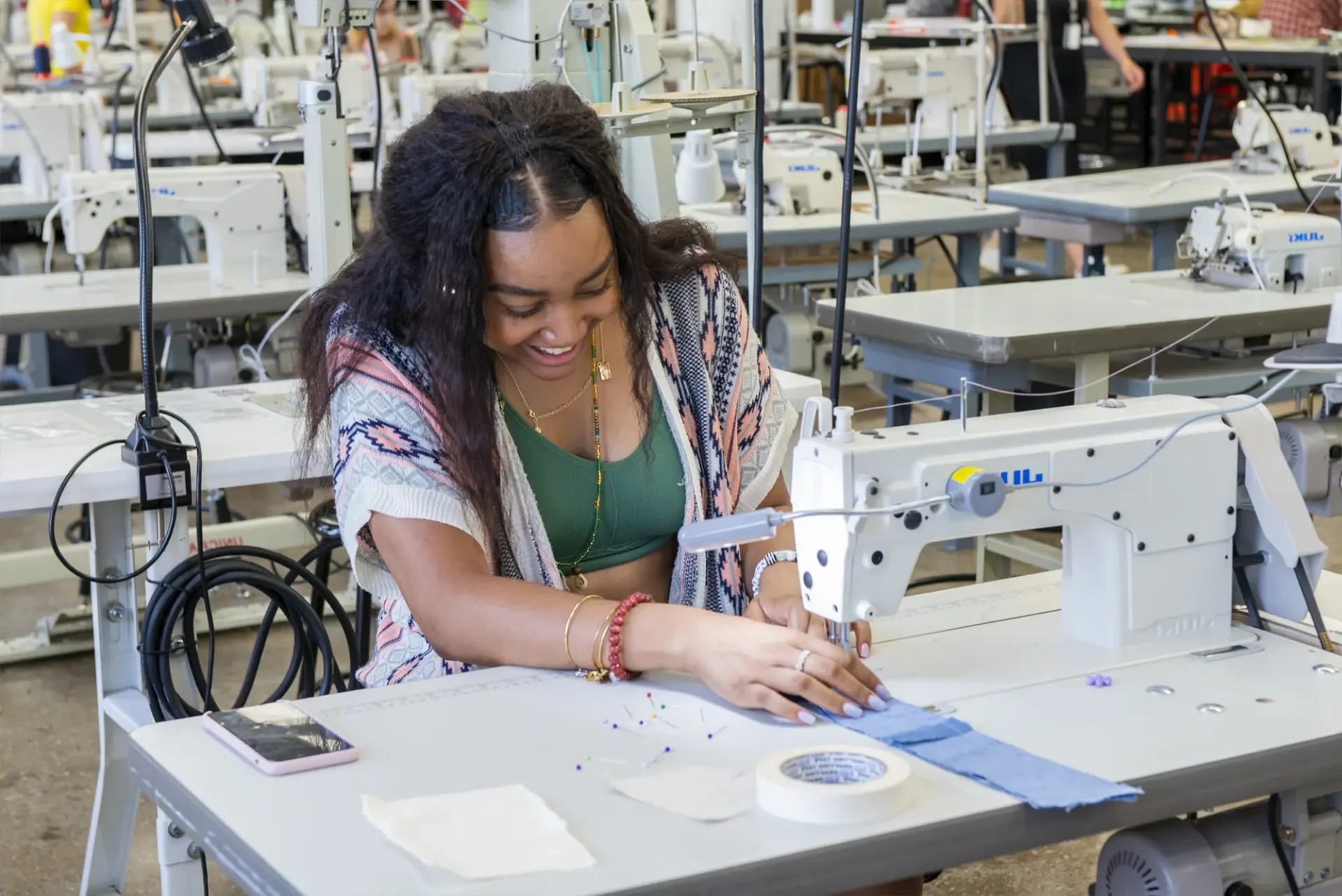 Precollege Summer Experience student sewing an apparel design.
