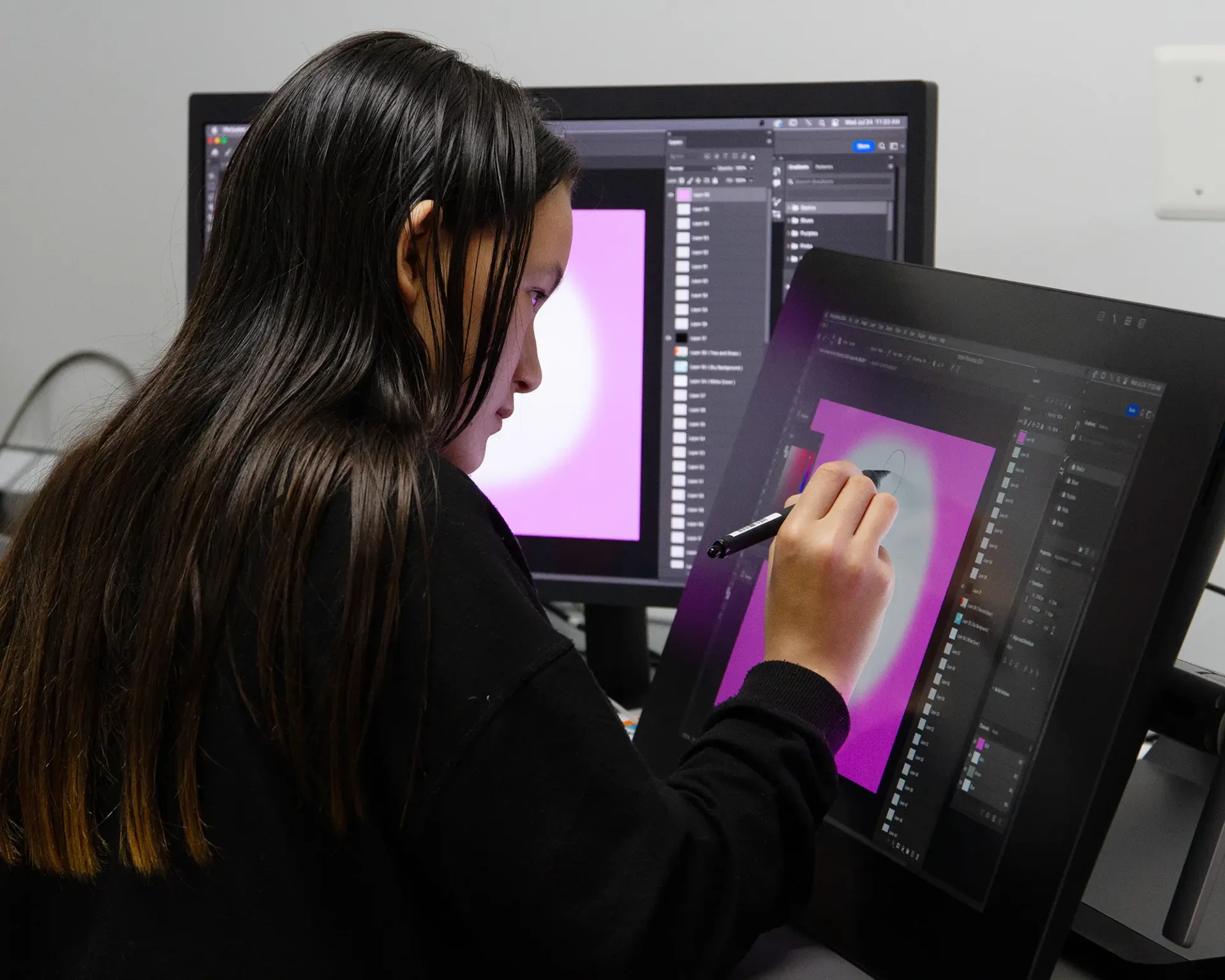 Dual Enrollment student working on a digital illustration on a tablet.