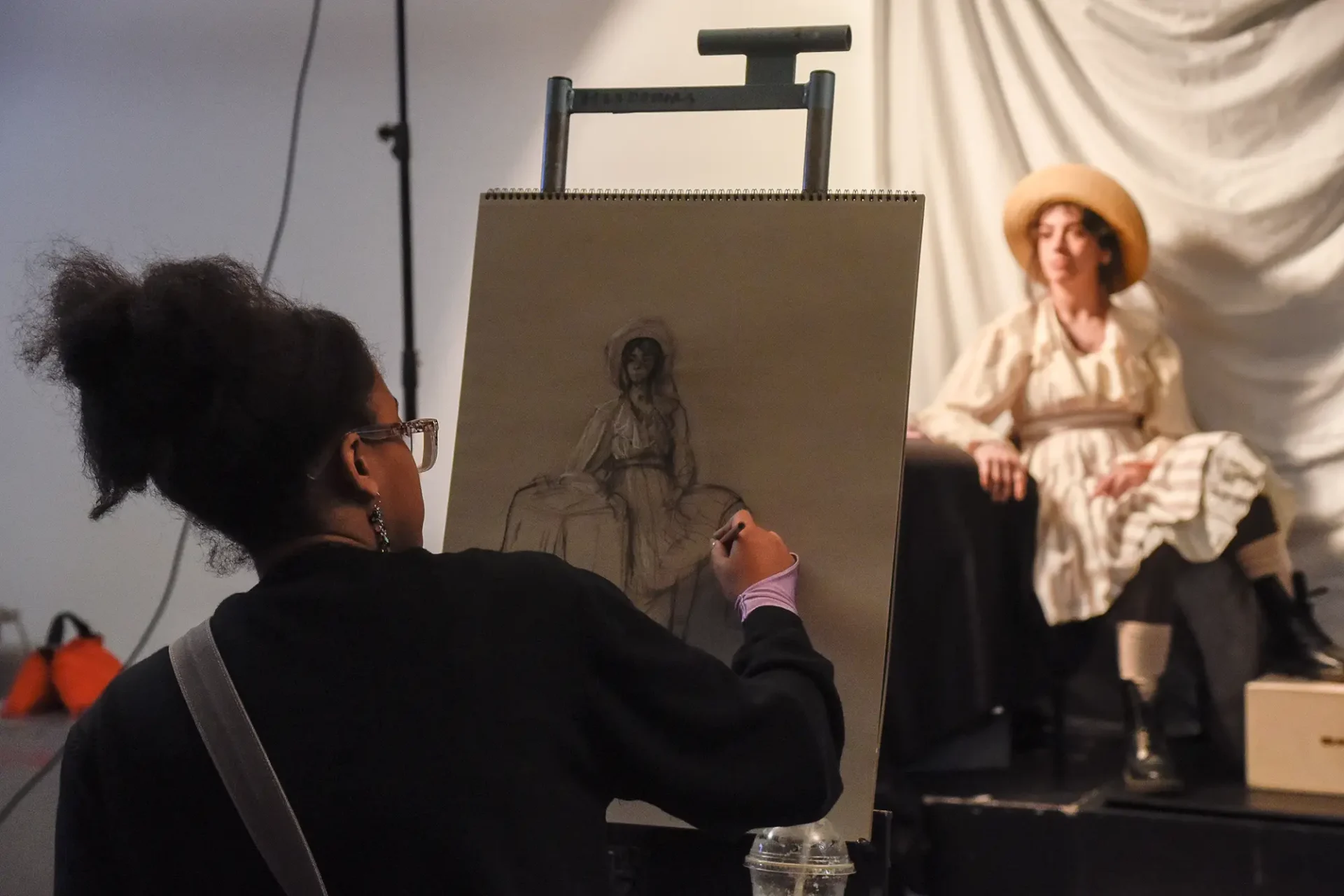 Student working on a charcoal figure drawing.