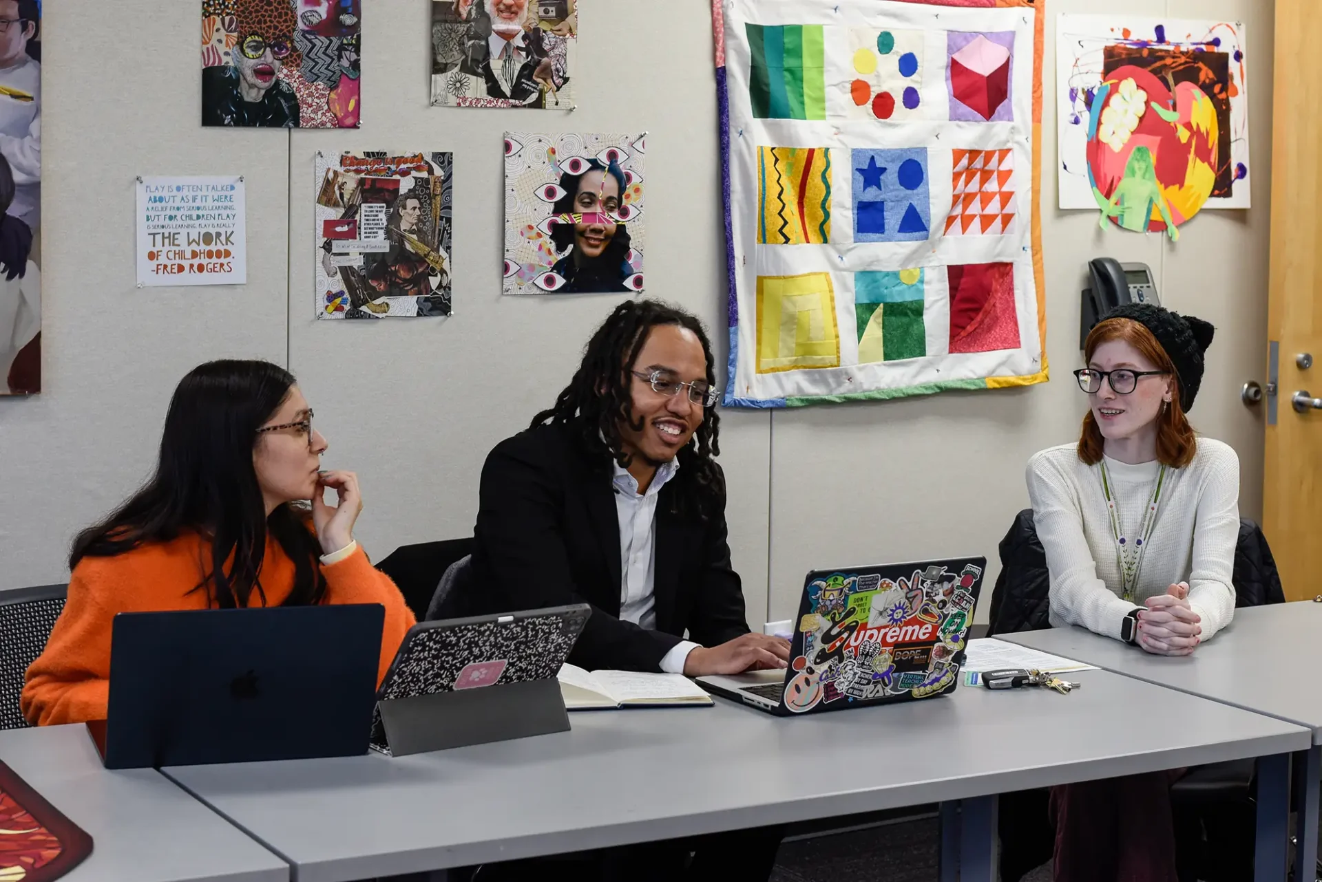 Students in an Art Education classroom discussing a project.