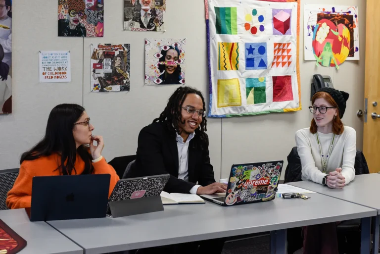 Students in an Art Education classroom discussing a project.