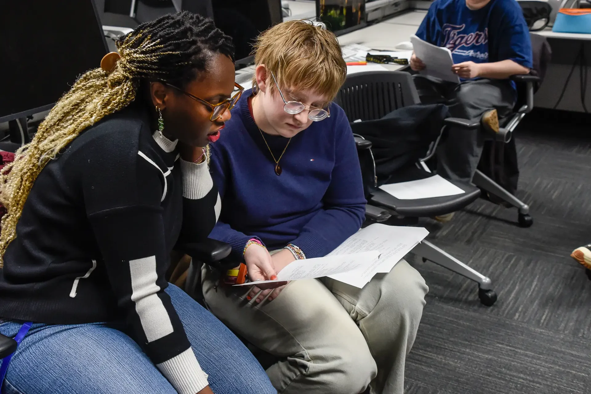 Two students reviewing papers.